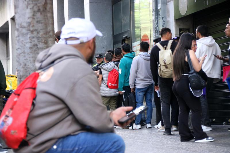 Migrants queue up outside the offices waiting to be attended to as part of Spain's extraordinary migrant regularization process