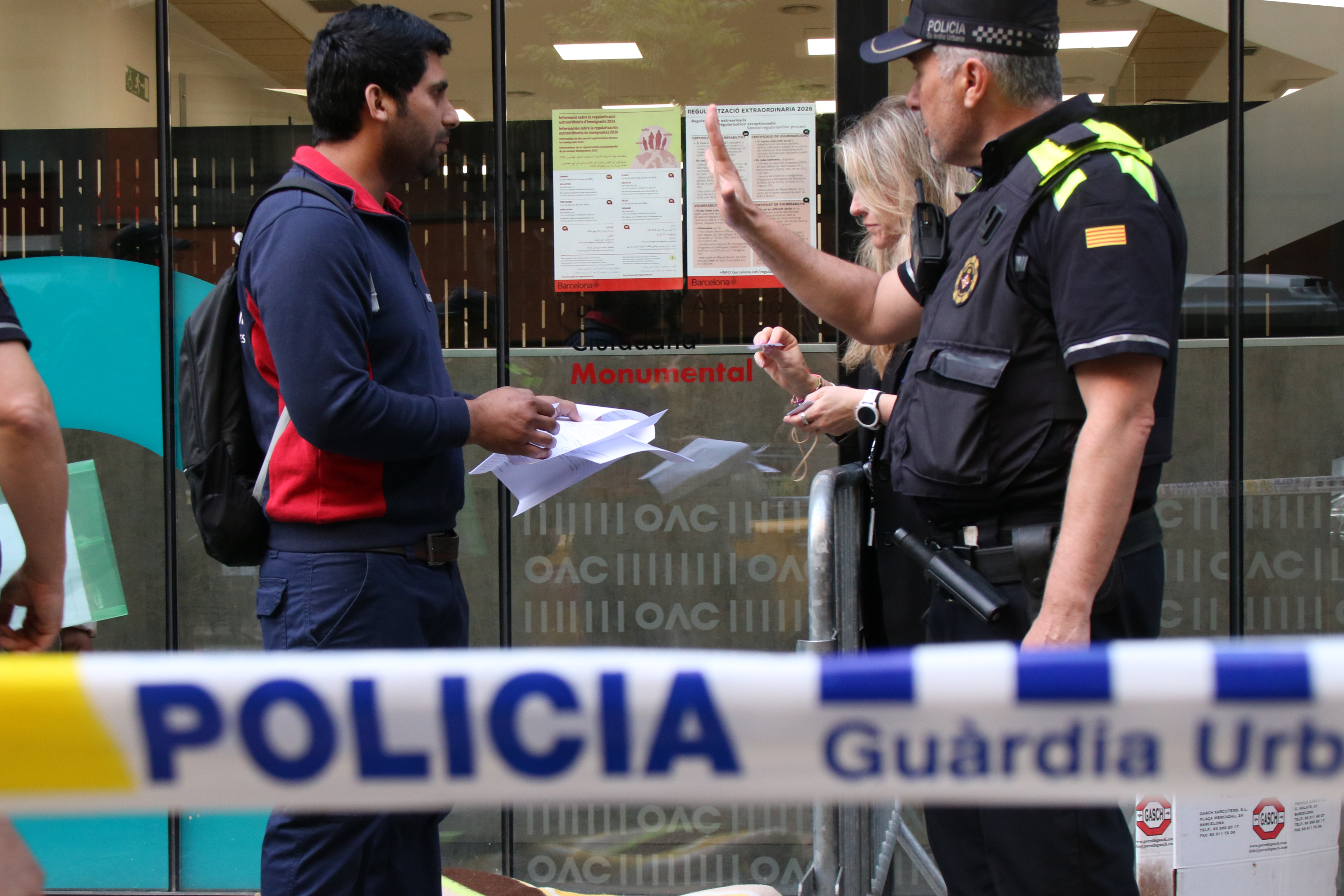 Police presence outside a migrant regularization attention office in Barcelona