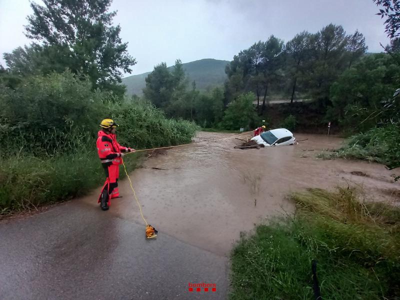 Firefighters recovering a car swept away by the river Cardener in Súria