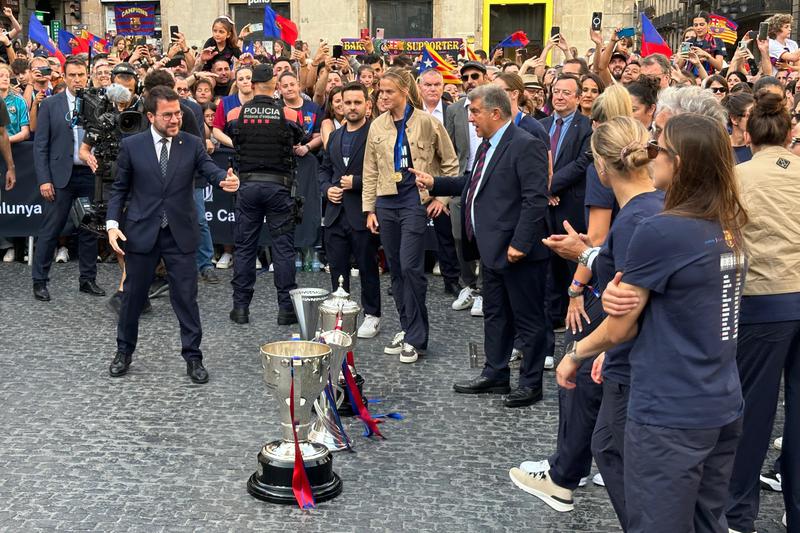 Barça Femení players with the 2023/24 season trophies with Catalan acting president Pere Aragonès and FC Barcelona president Joan Laporta at Plaça Sant Jaume square on May 26, 2024