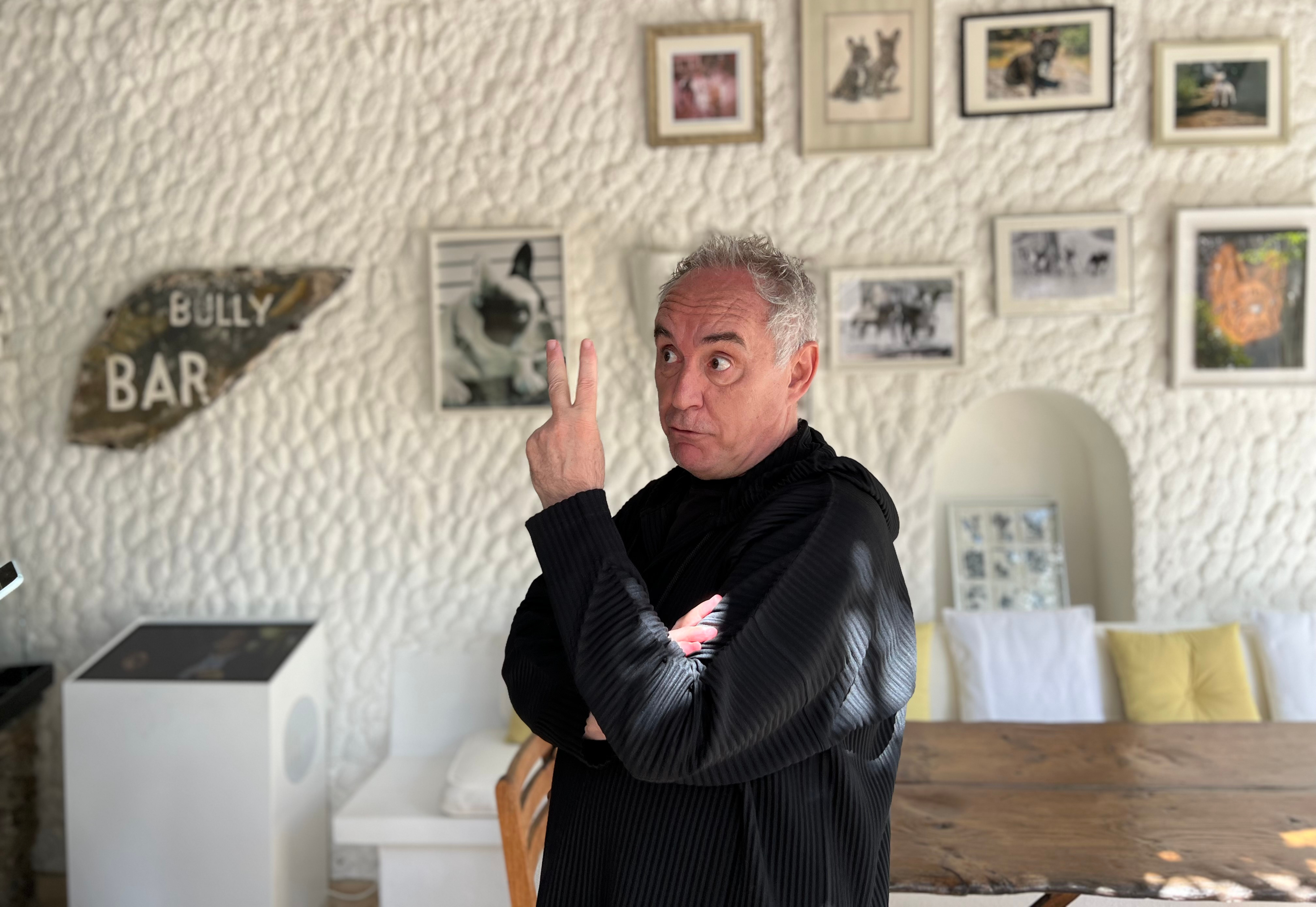Chef Ferran Adrià at ElBulli1846 museum in front of French bulldogs pictures hanging on the wall
