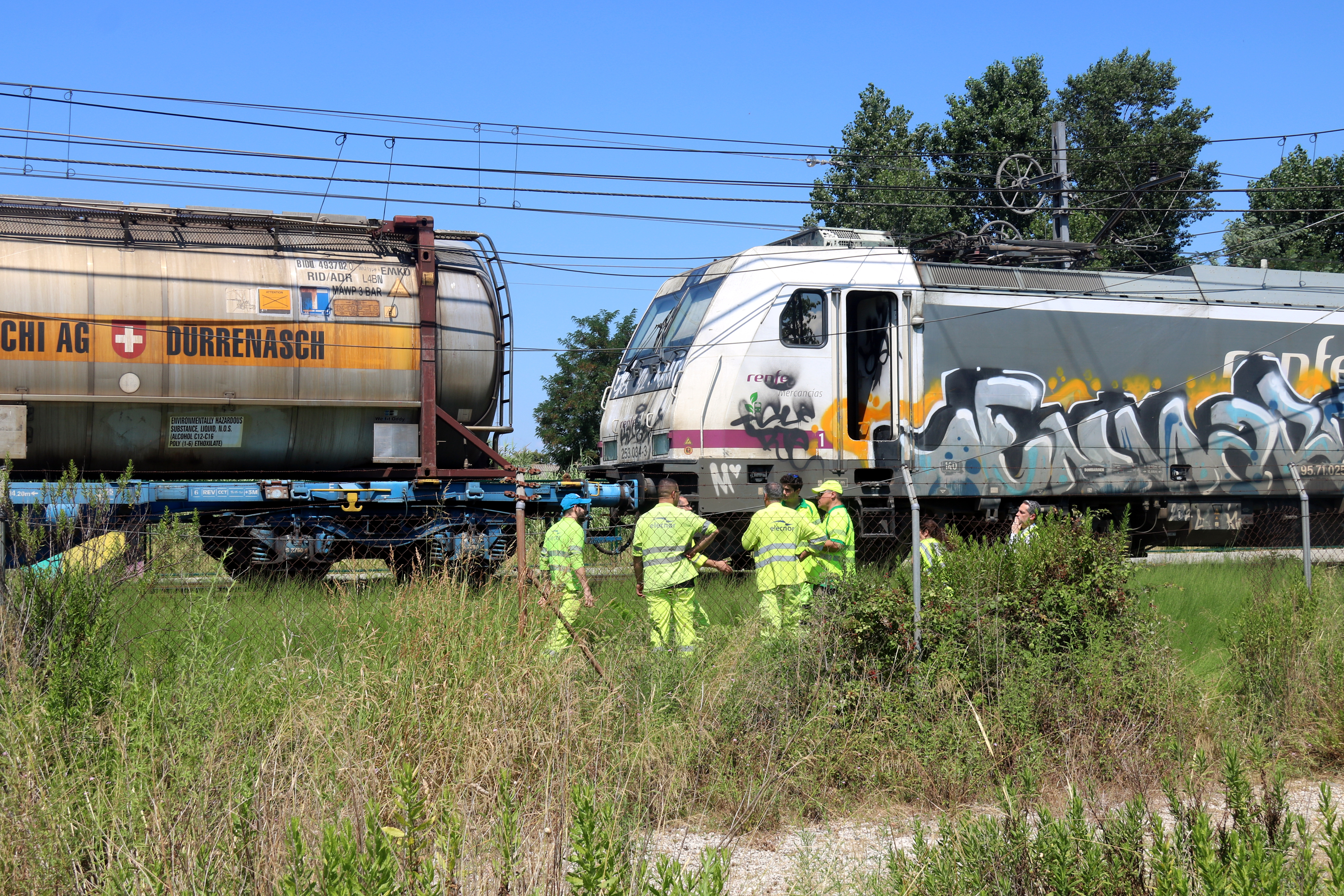 Experts next to a train that was burned down near Girona on July 25, 2024