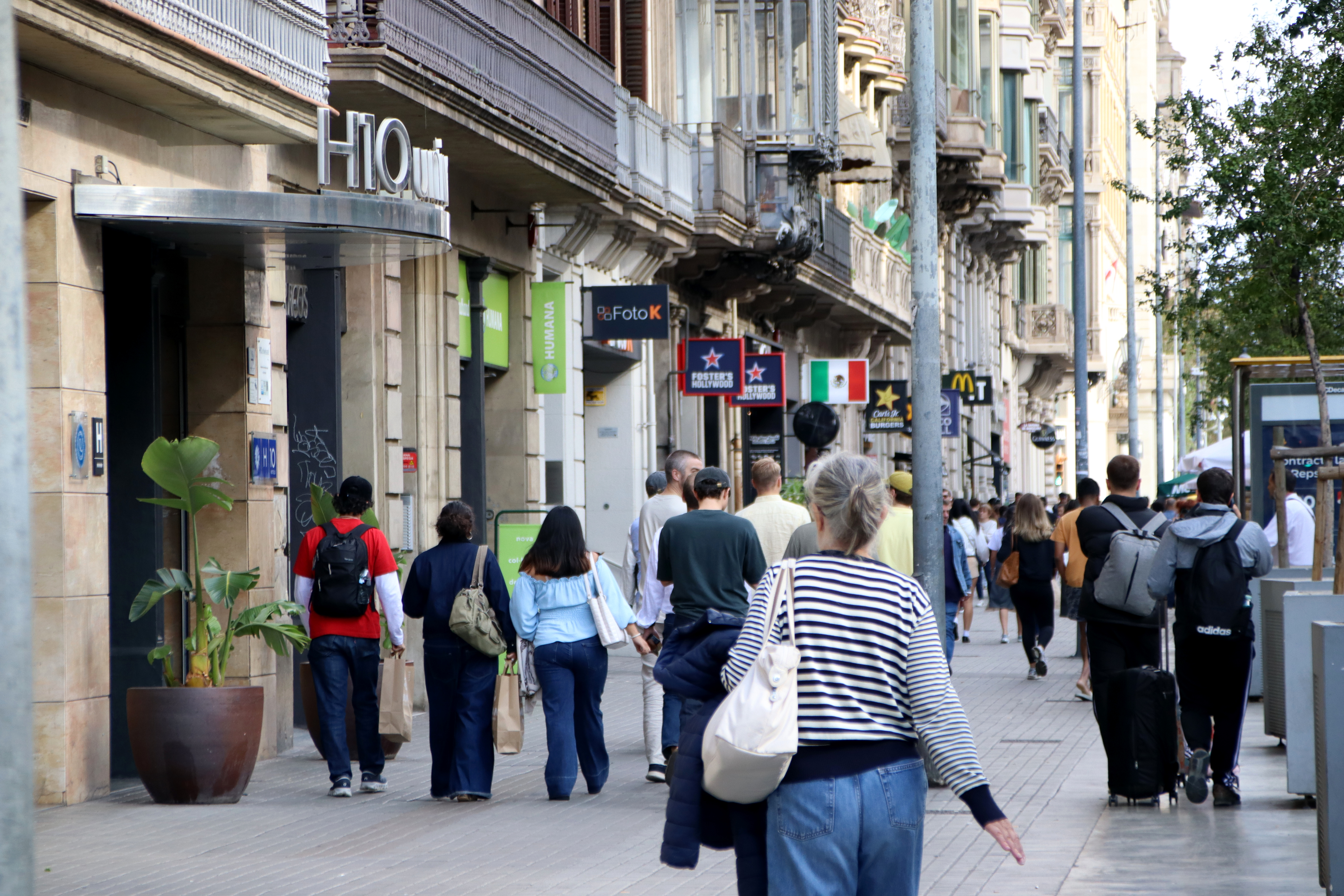 People walking in Barcelona city centre, on Ronda Universitat