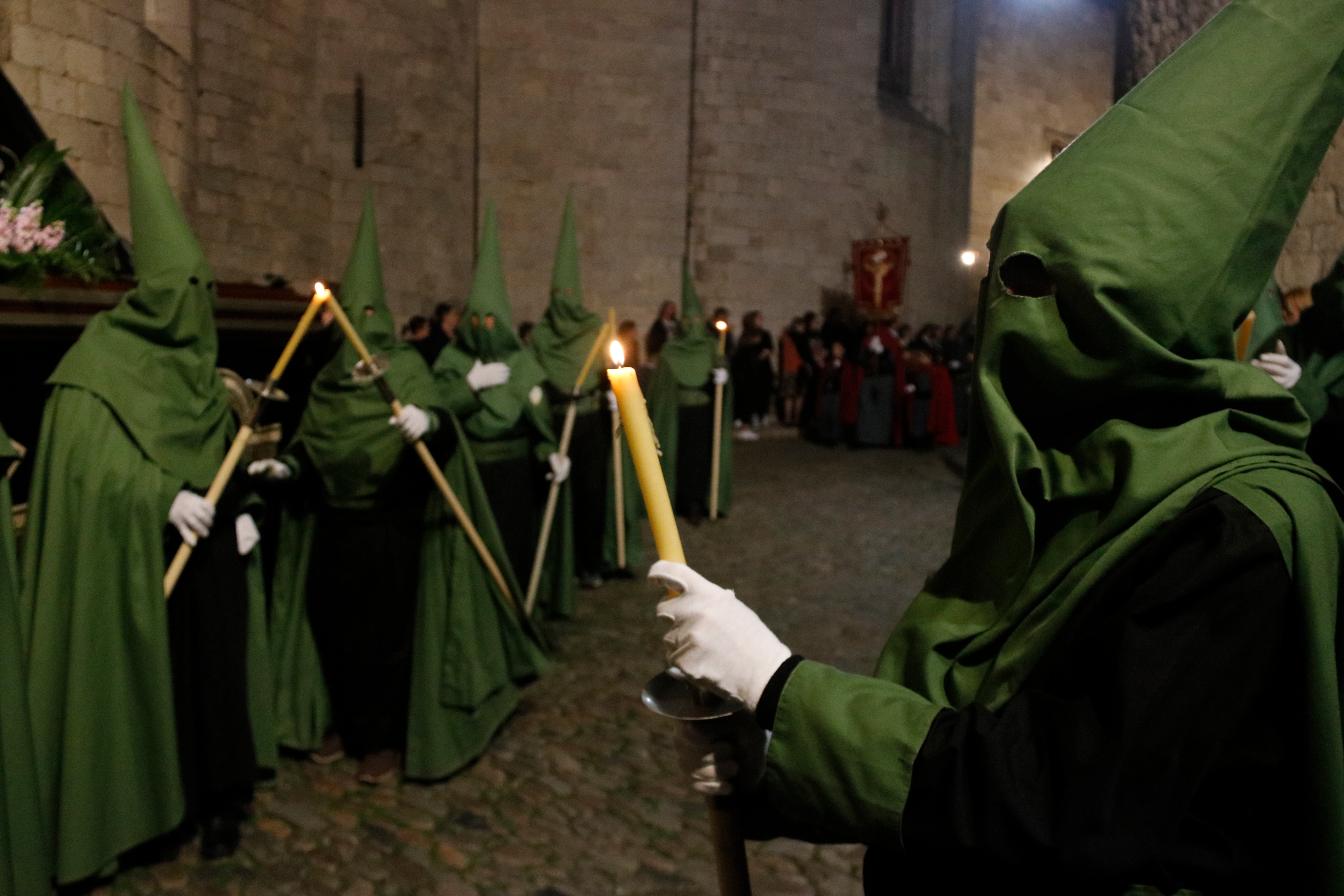 One of the confraternities in Girona holding candles during the procession on 2022 Good Friday