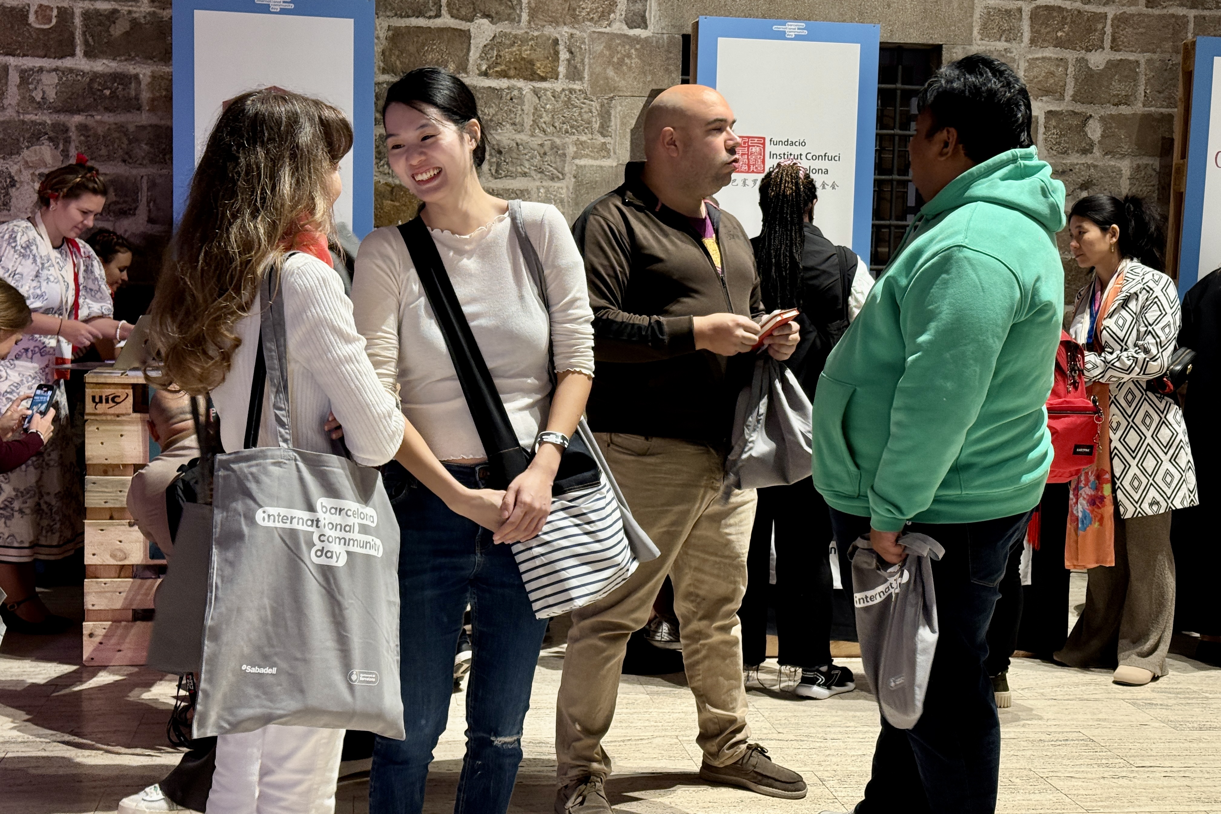 Several attendees speaking at the 2025 Barcelona International Community Day on October 25, 2025