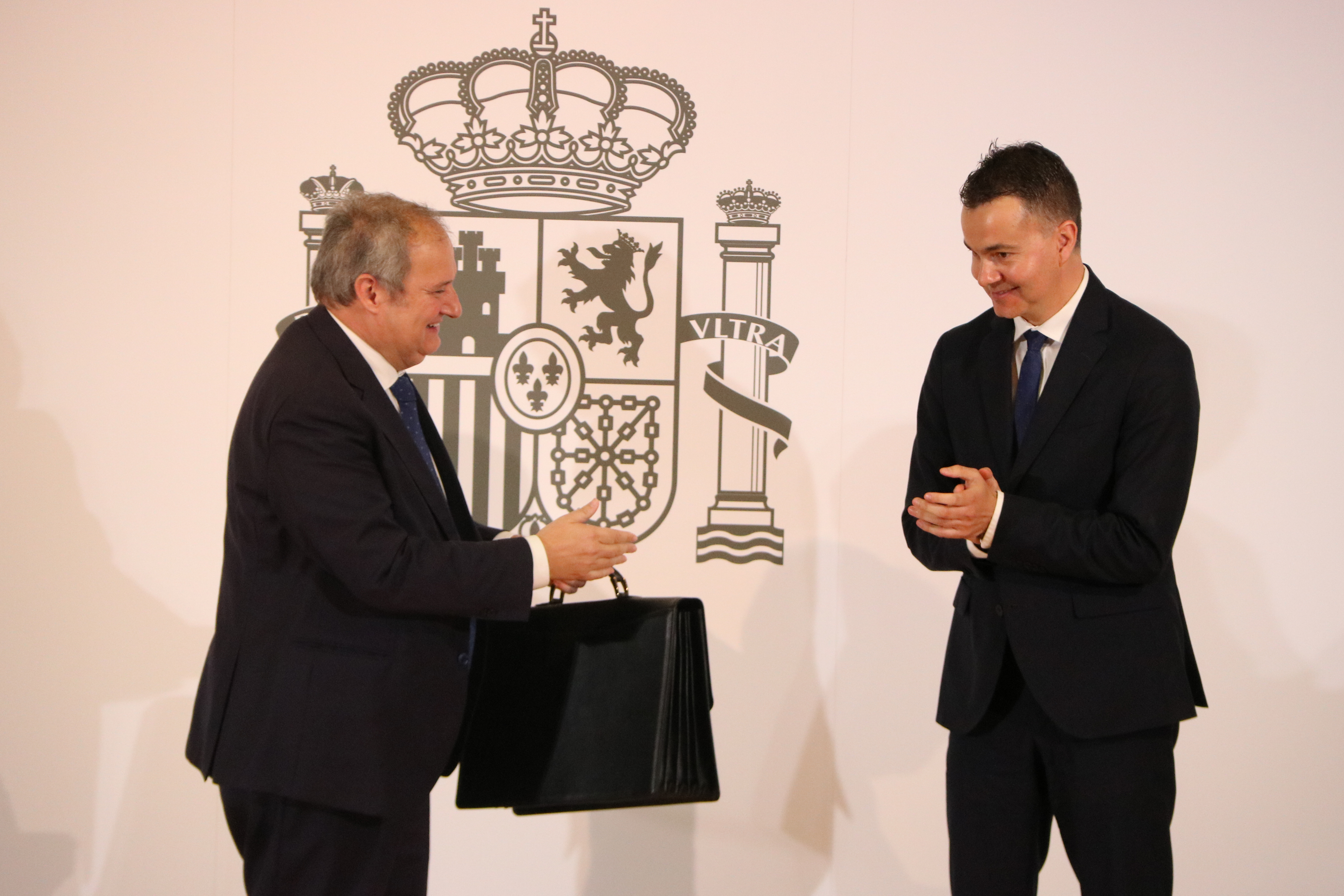 Spain's new industry minister, Jordi Hereu, receives the department portfolio from his predecessor, Héctor Gómez