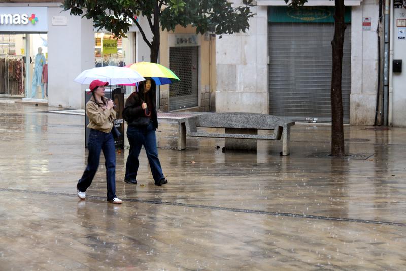 People walking in rain in Figueres