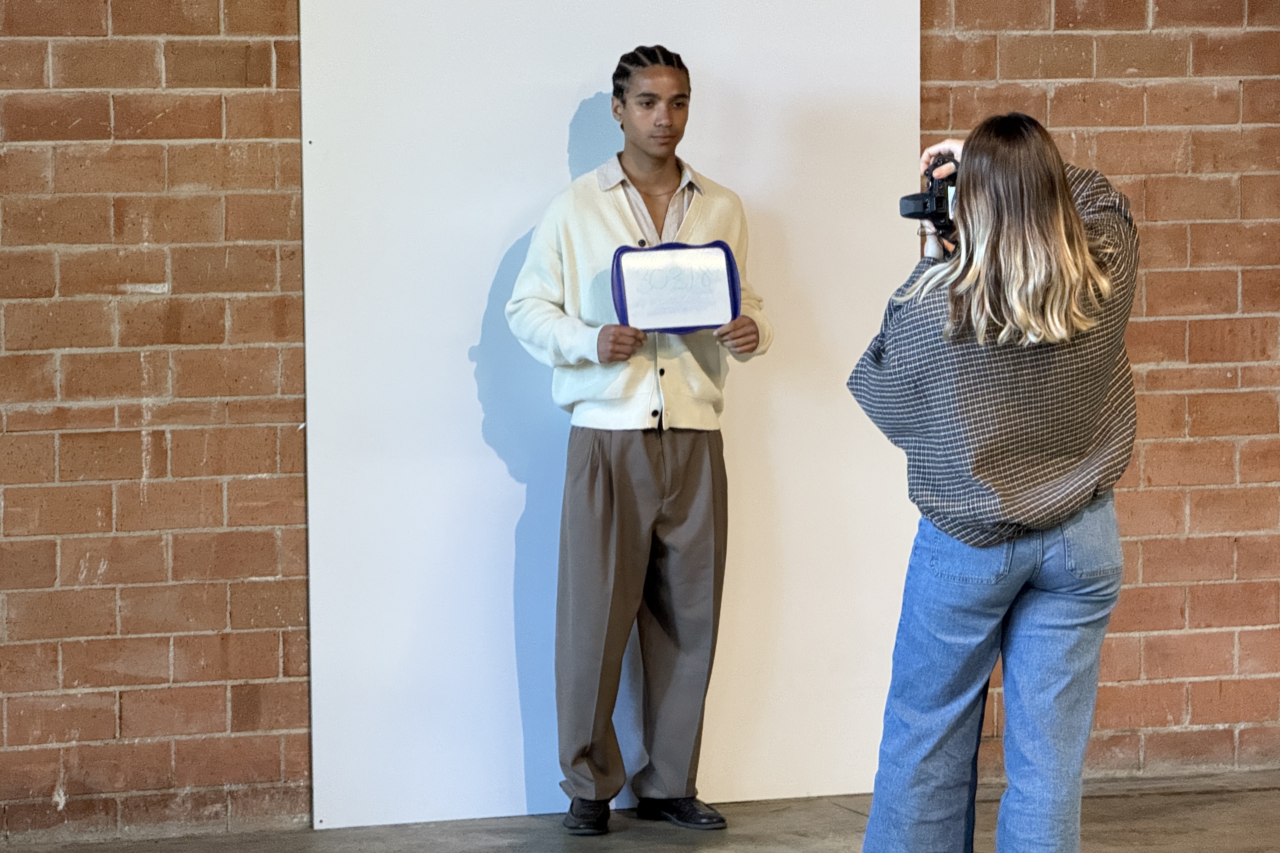 A person from the company organizing the casting for extras for ‘Tangled’ in Girona takes a photo of one of the applicants.