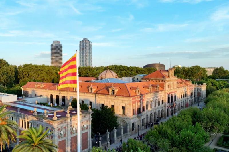 The Catalan flag waves next to the Catalan parliament