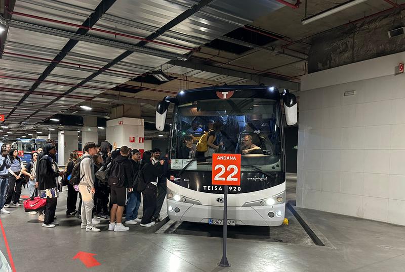 Passengers board a bus at Girona station.