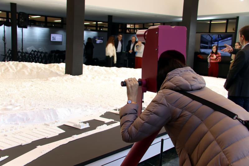 A person uses one of the viewing devices to explore the Barcelona model on display at the former headquarters of Editorial Gustavo Gili