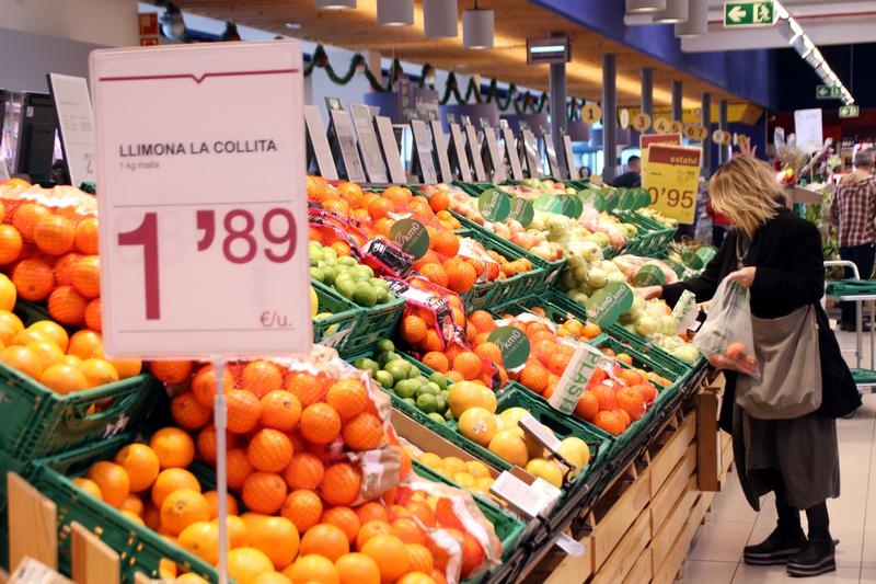 A shopper buying fruit and vegetables in a market