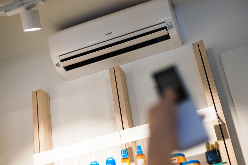 A person turning on an AC