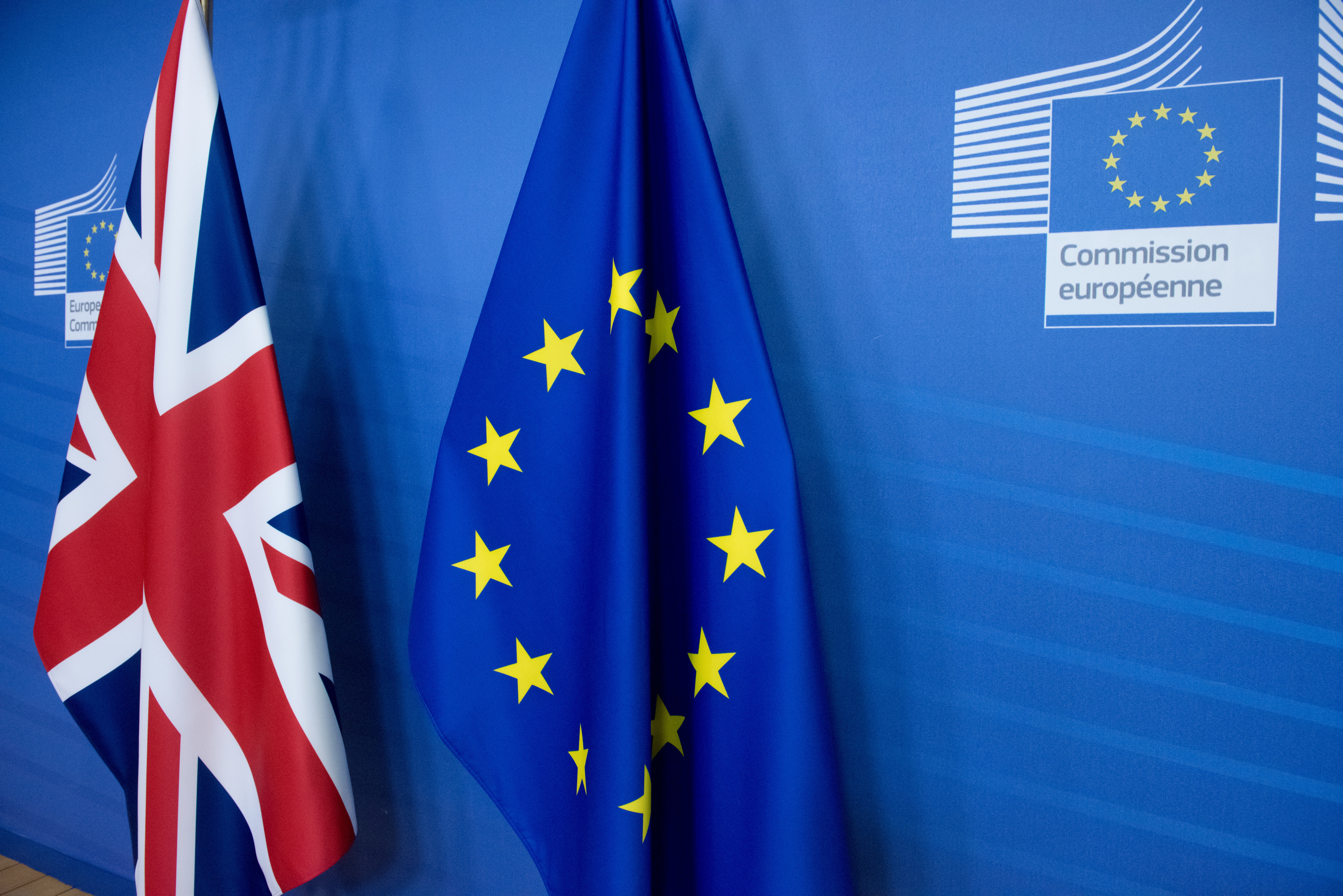 A Union Jack flag beside a European Union one in the EU Commission