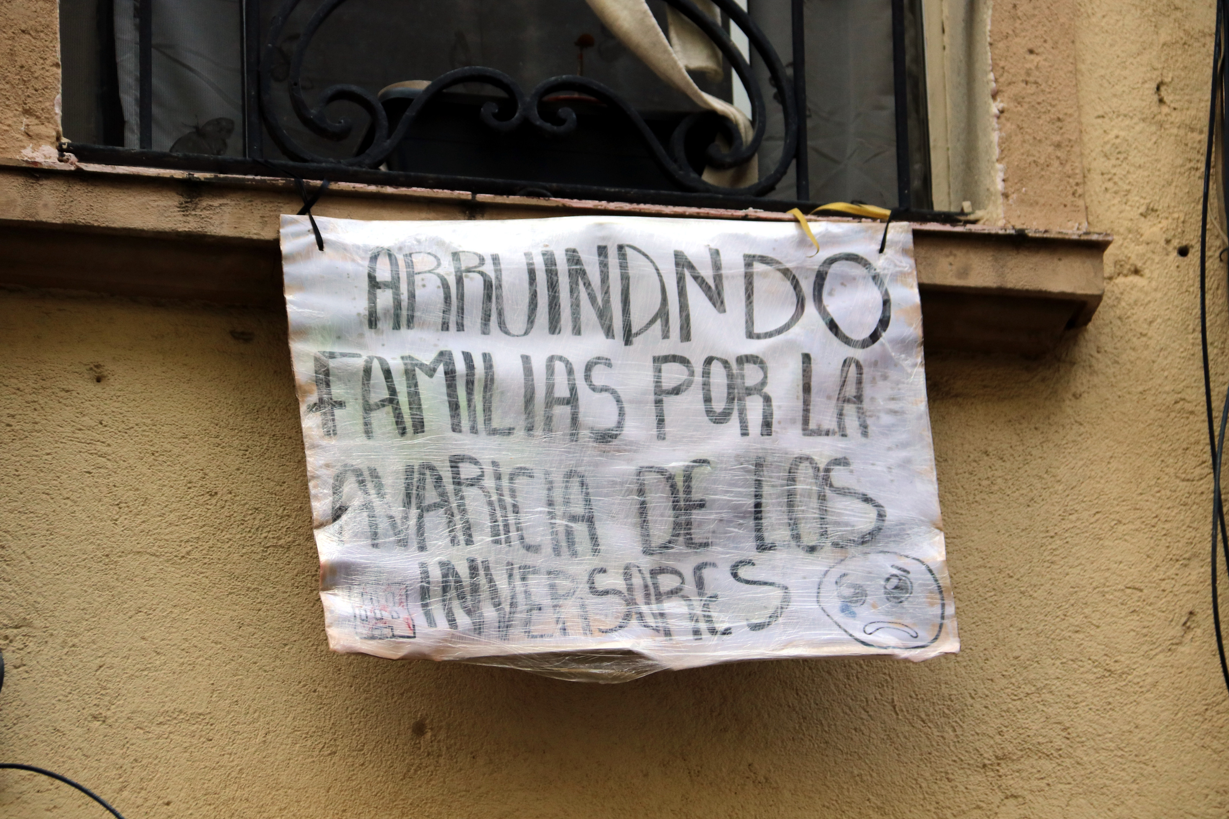 A sign against evictions hung from an apartment window in L'Hospitalet