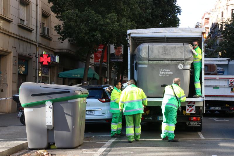 Barcelona council cleaning services remove the grey trash container where human remains were discovered
