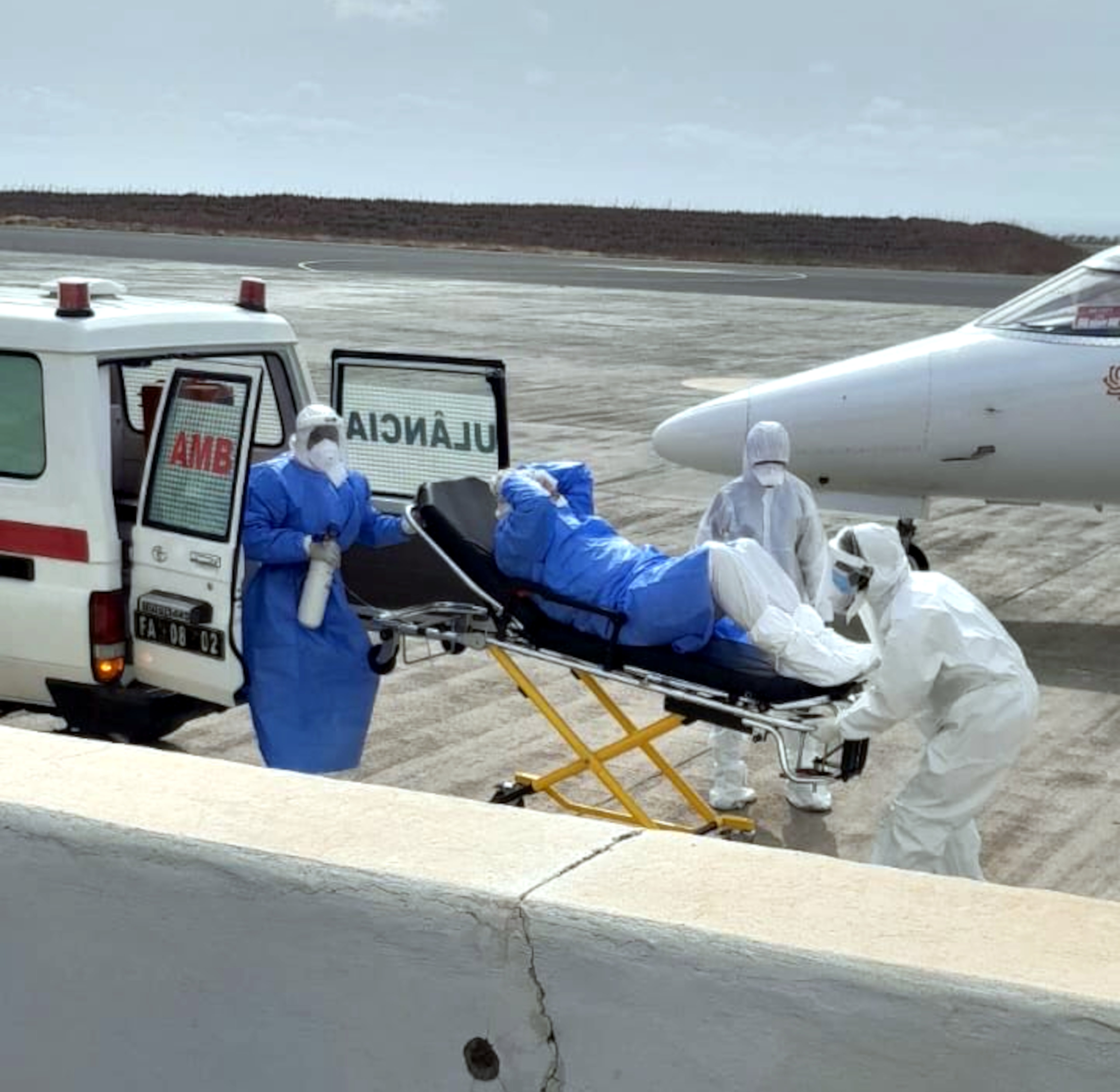 Health workers transfer a hantavirus patient from an ambulance to a medical aircraft
