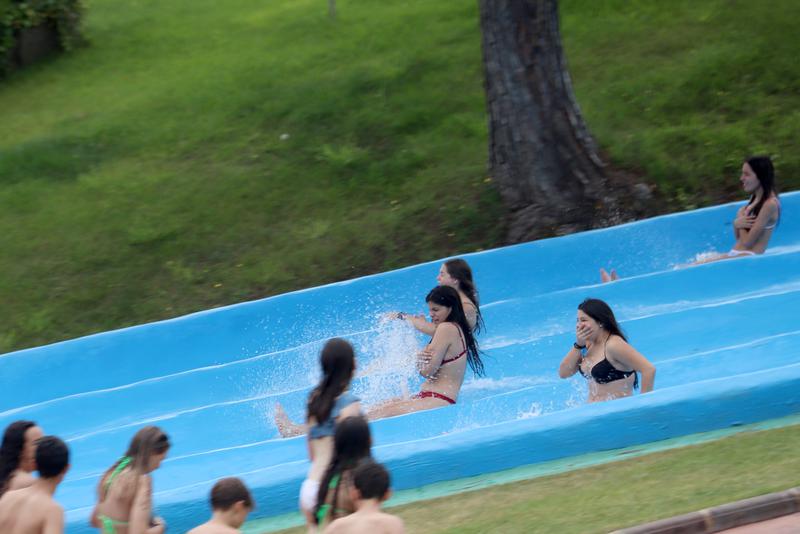 People go down a slide at the Waterworld water park in Lloret de Mar