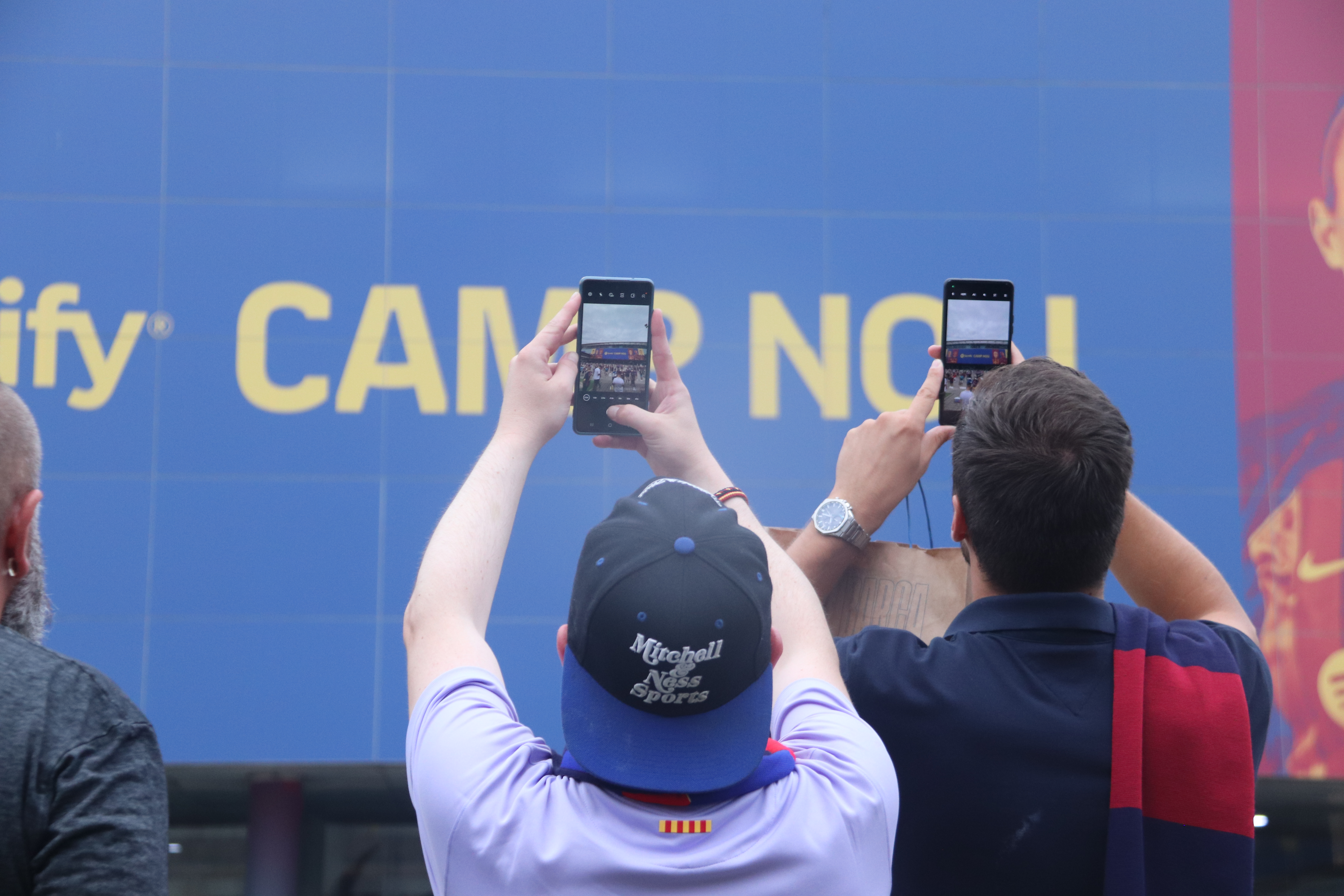 Barça fans take a photo of FC Barcelona's Camp Nou stadium before a match