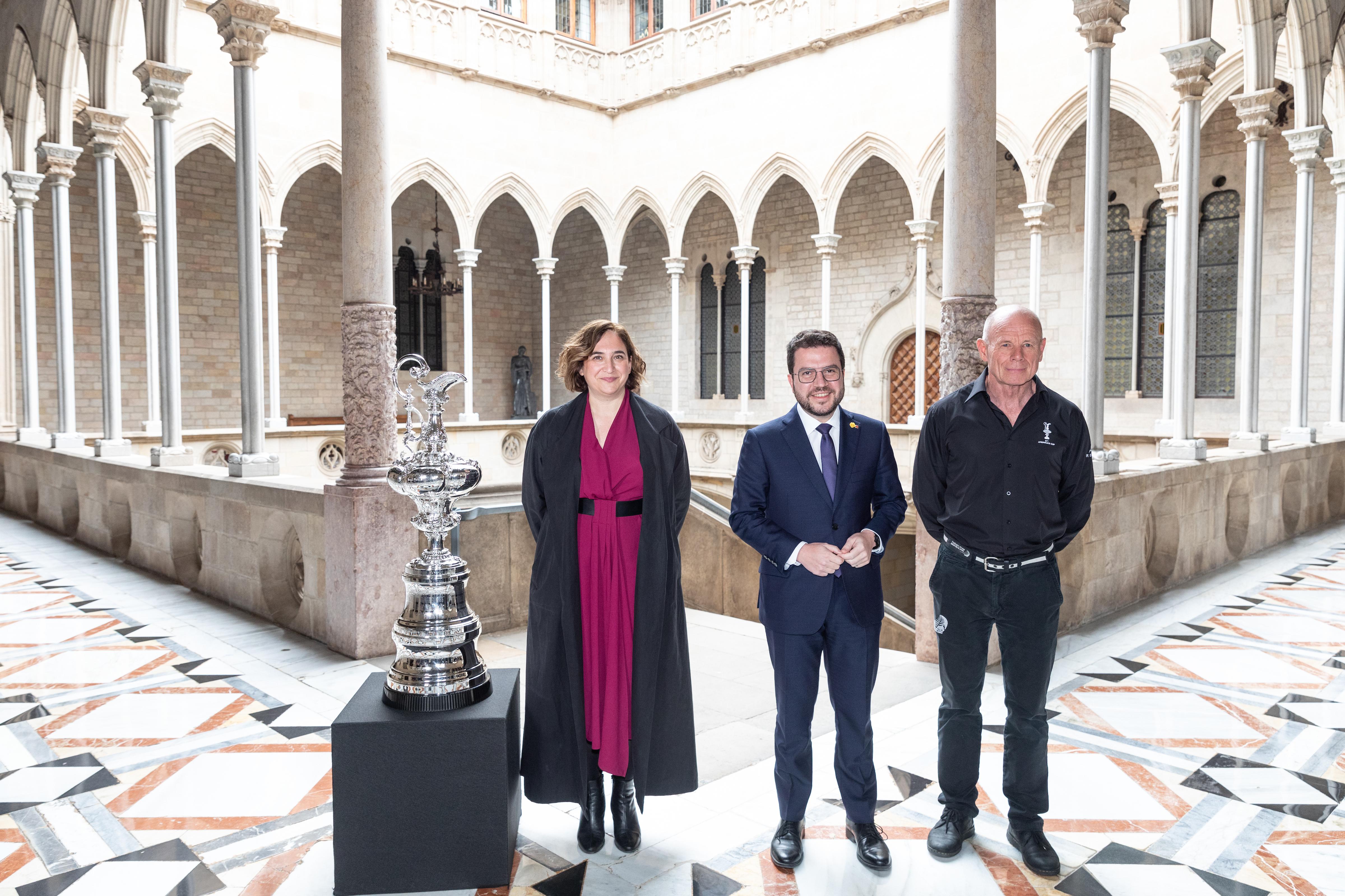 Former Barcelona mayor Ada Colau with former president Pere Aragonès and America's Cup CEO Grant Dalton next to sailing competition's 'The Mug' award in the Catalan government headquarters on March 29, 2022