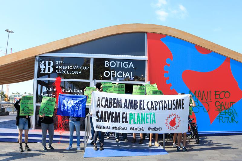 A group of pro-environmental activists block the entrance to the Barcelona's America's Cup official store during a demonstration on June 5, 2024