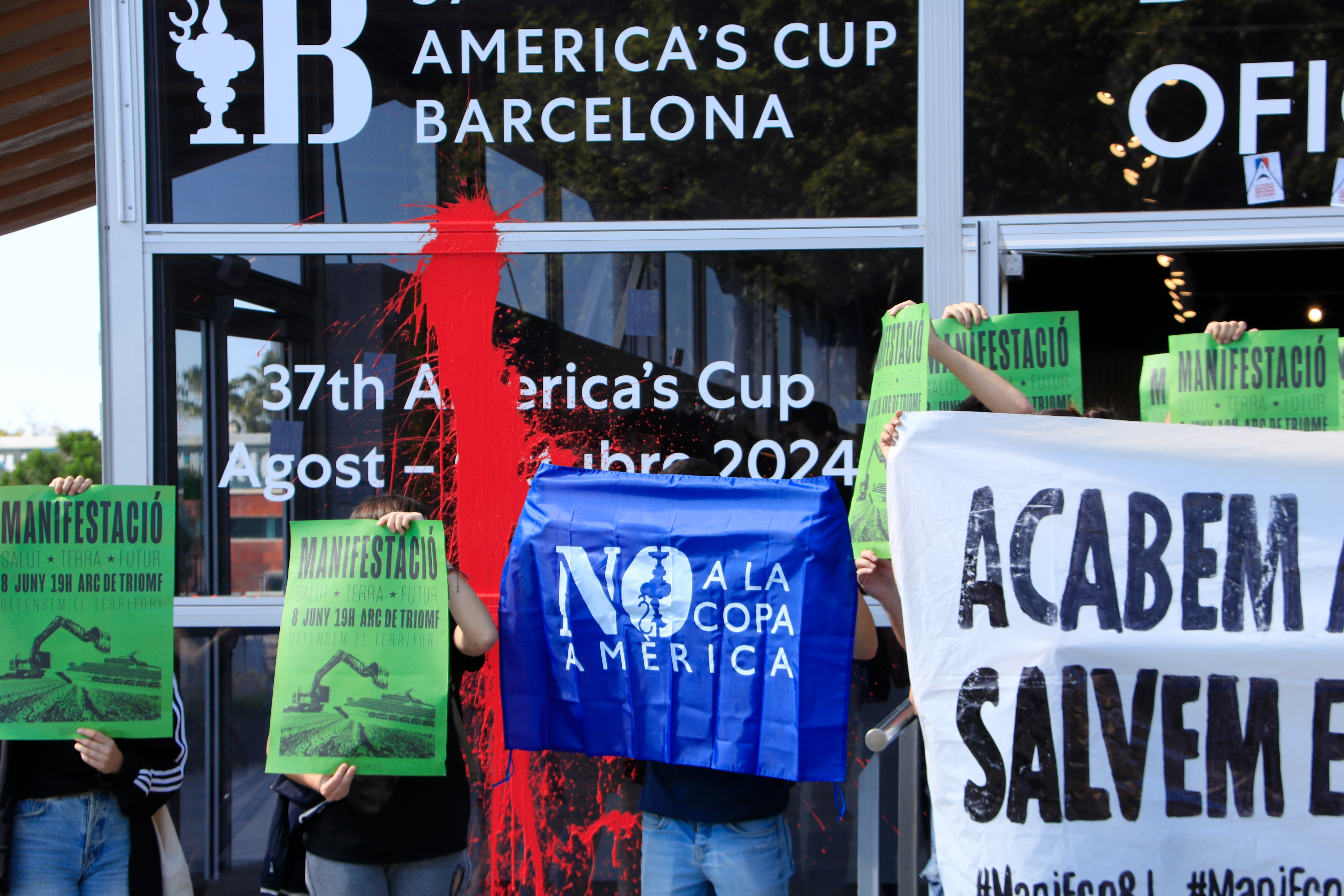 Pro-environmental activists demonstrate in front of Barcelona's America's Cup official store on June 5, 2024