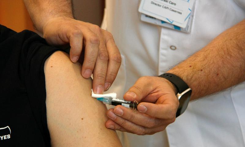 A nurse administering a HPV vaccine to a 17-year-old