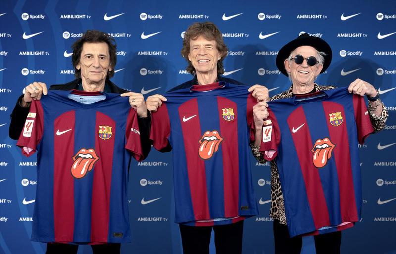 Mick Jagger, Keith Richards and Ronnie Wood of The Rolling Stones pose with the FC Barcelona jersey featuring their band logo