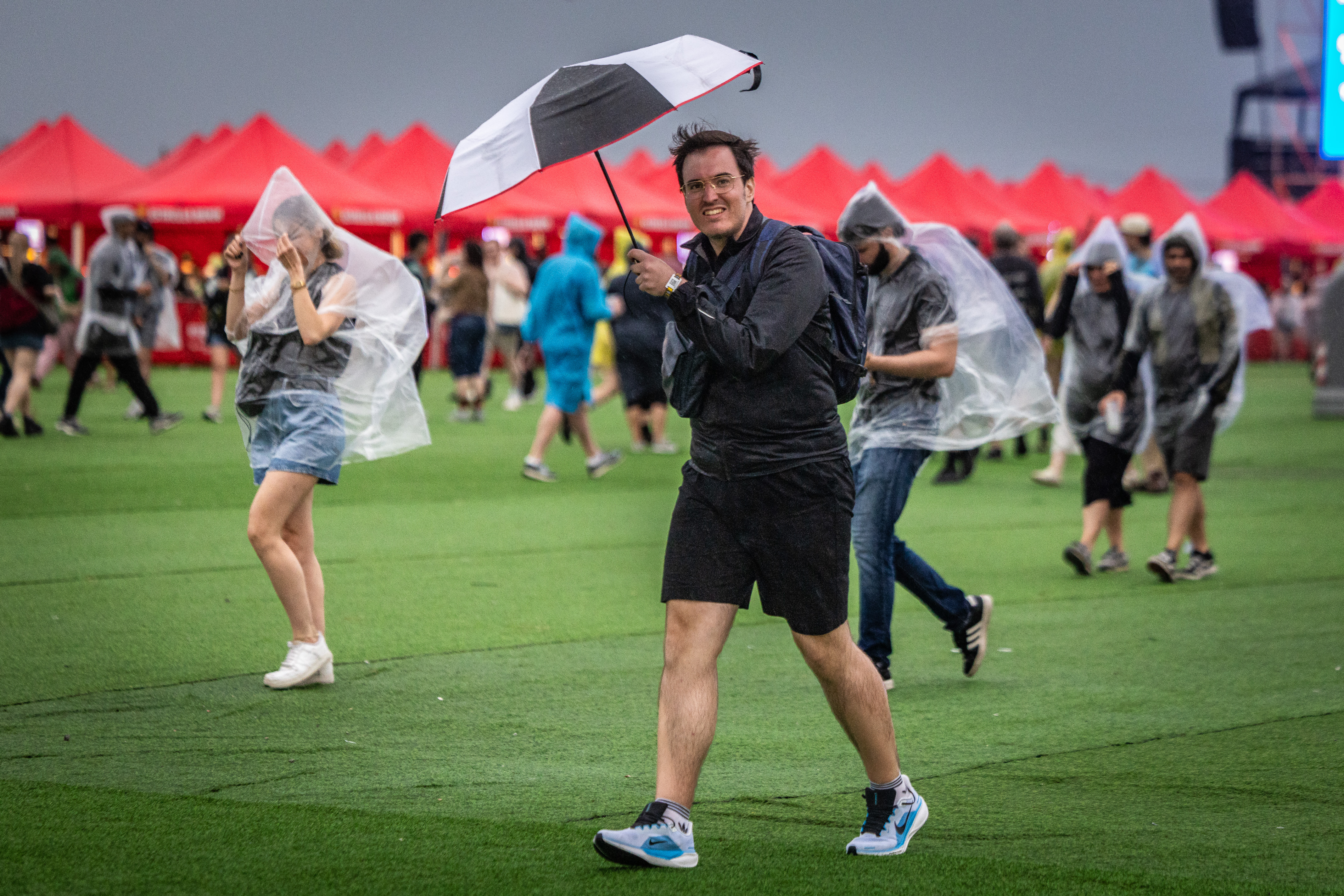 With ponchos and umbrellas, fans try to protect themselves from the rain