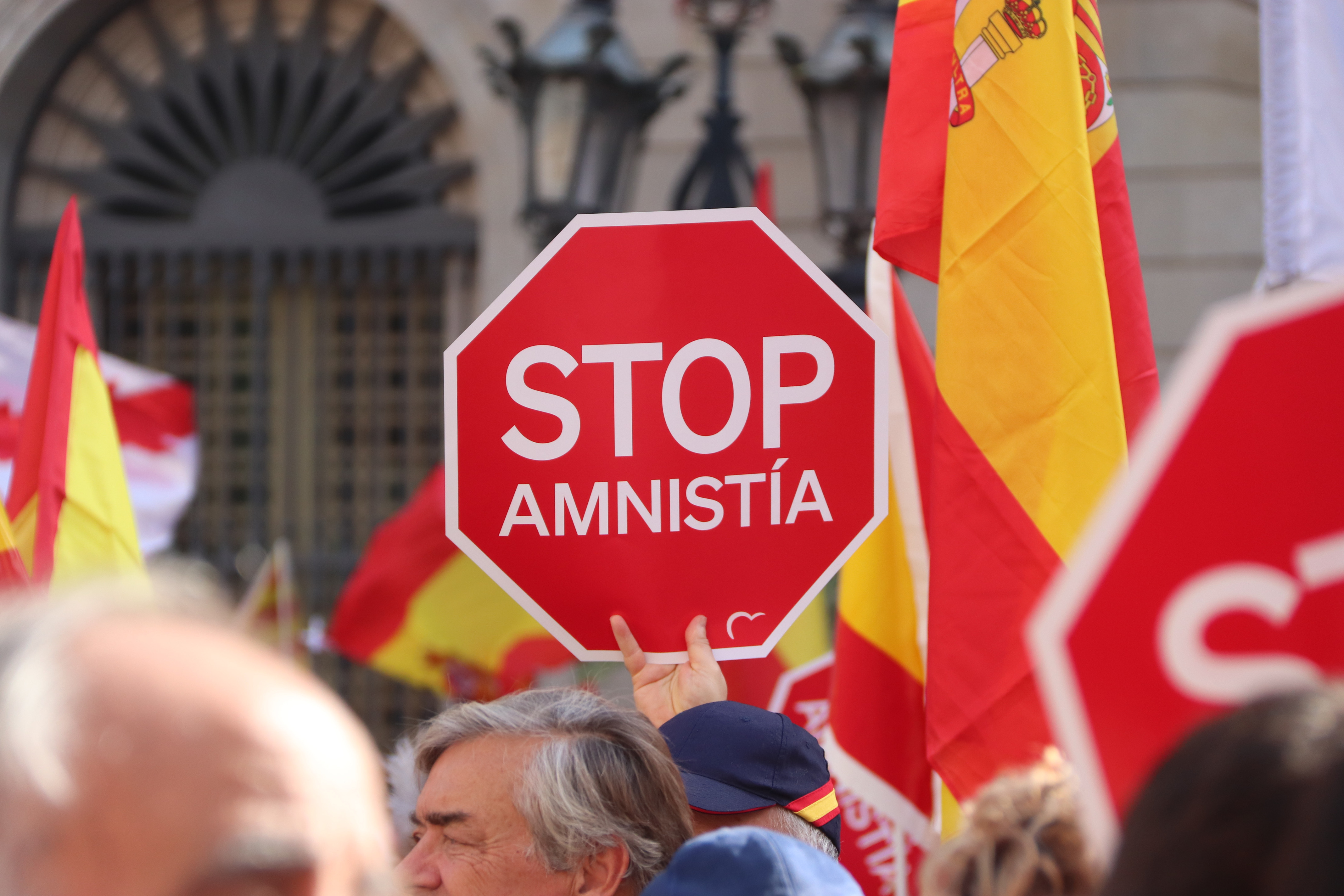 A poster reads 'Stop Amnesty' during an anti-amnesty law demonstration in Barcelona on November 12, 2023