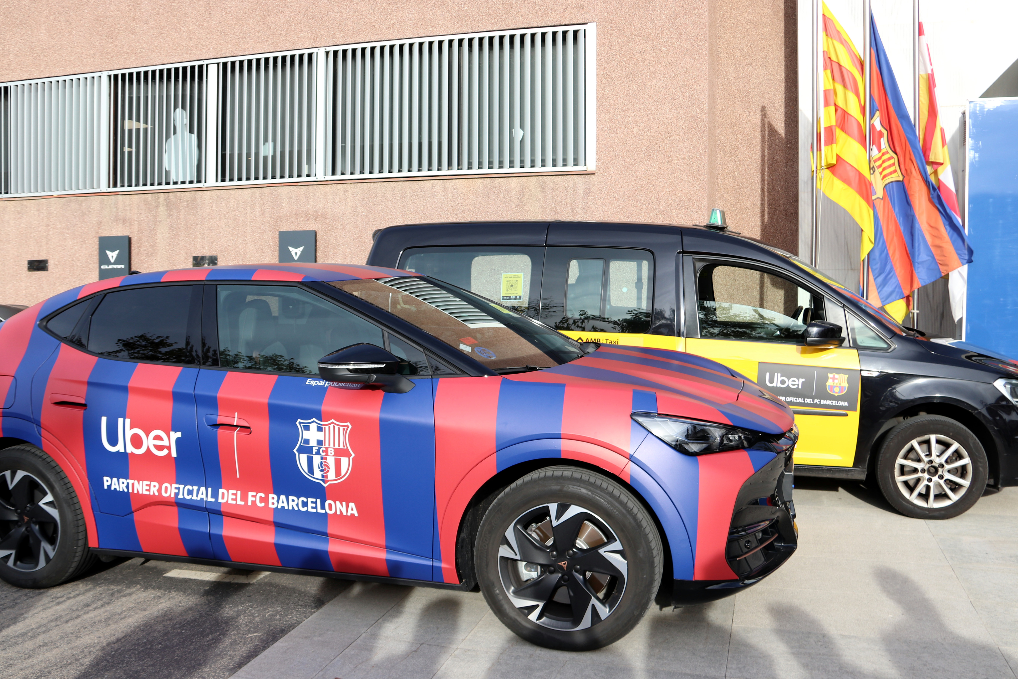 Two cars with the Uber and FC Barcelona logos at the signing ceremony of the sponsorship agreement between the club and the platform
