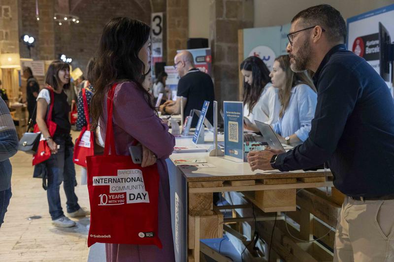 A visitor to the 2023 Barcelona International Community Day browses one of the stalls