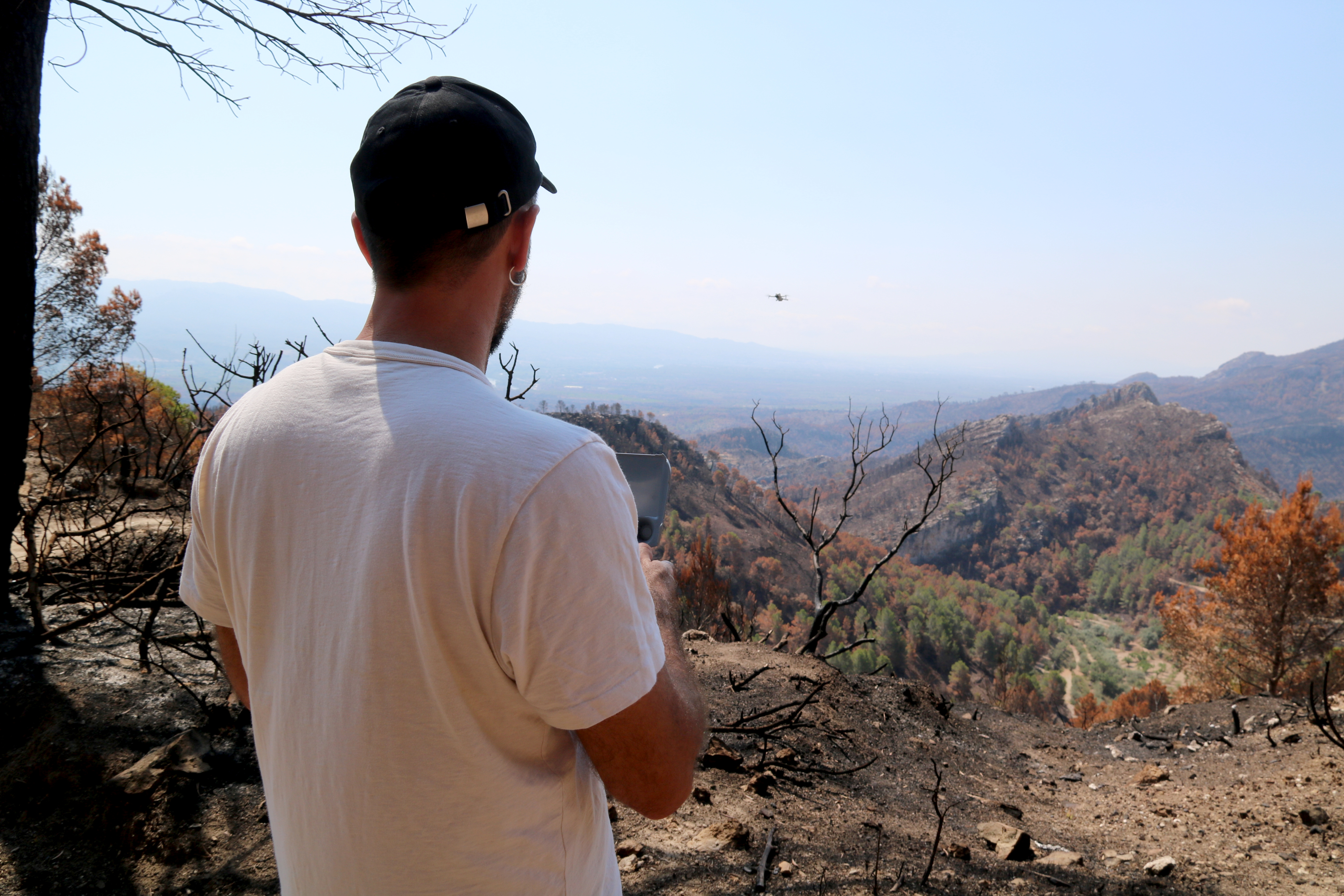 Photographer Jordi Borràs capturing drone footage of the forest fire aftermath