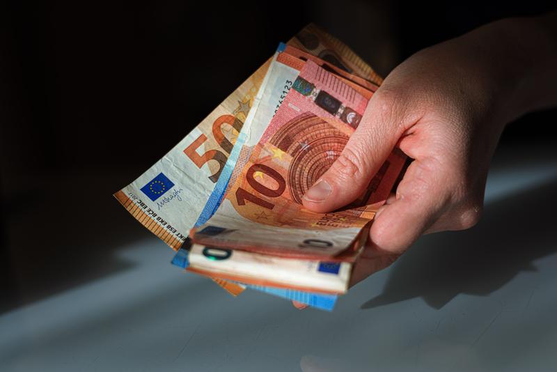 A hand holding several euro notes in a file picture