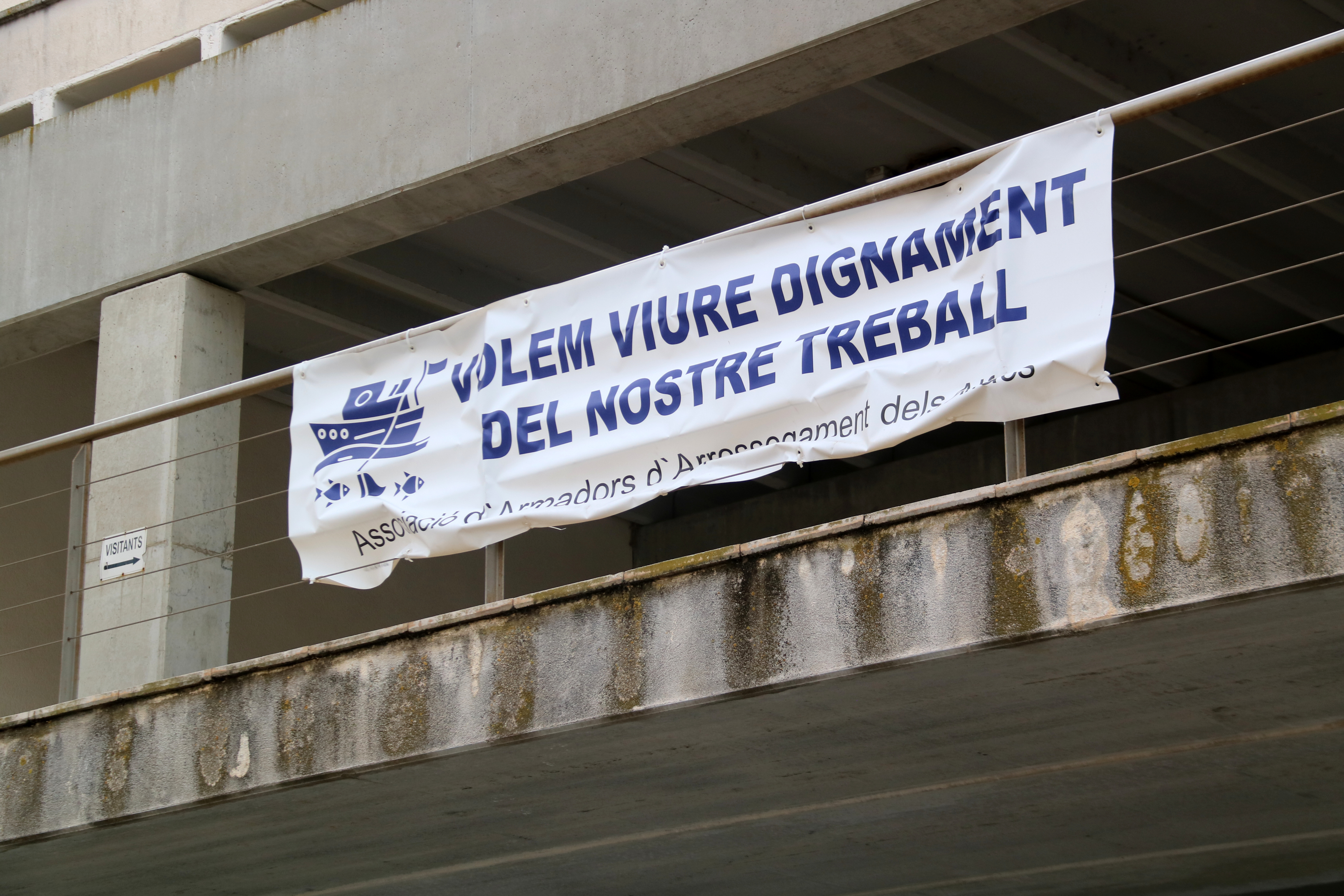 "We want a dignified job," reads a protest sign in La Ràpita