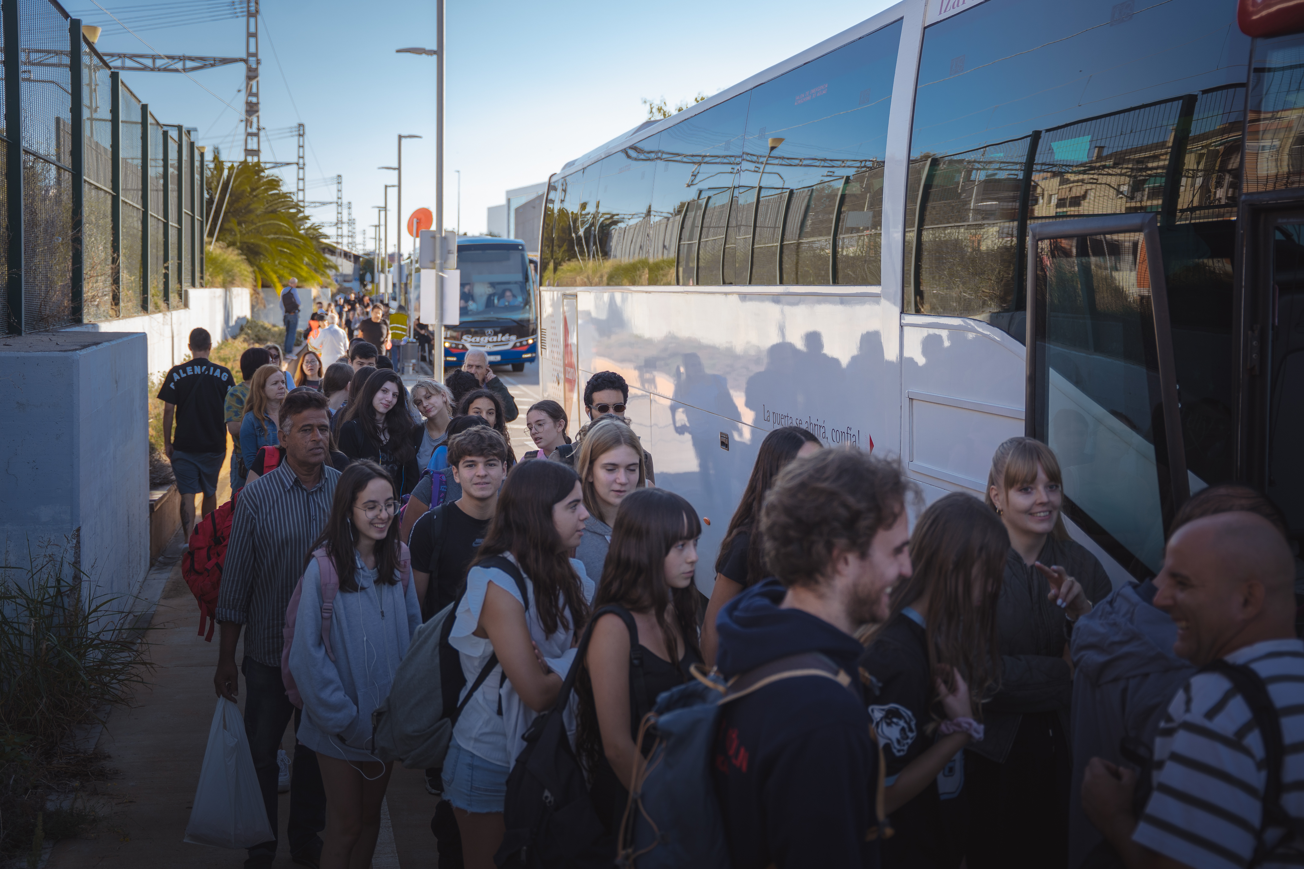 Passengers taking buses through the railway crossing on the R2 Sud between Gavà and Sitges