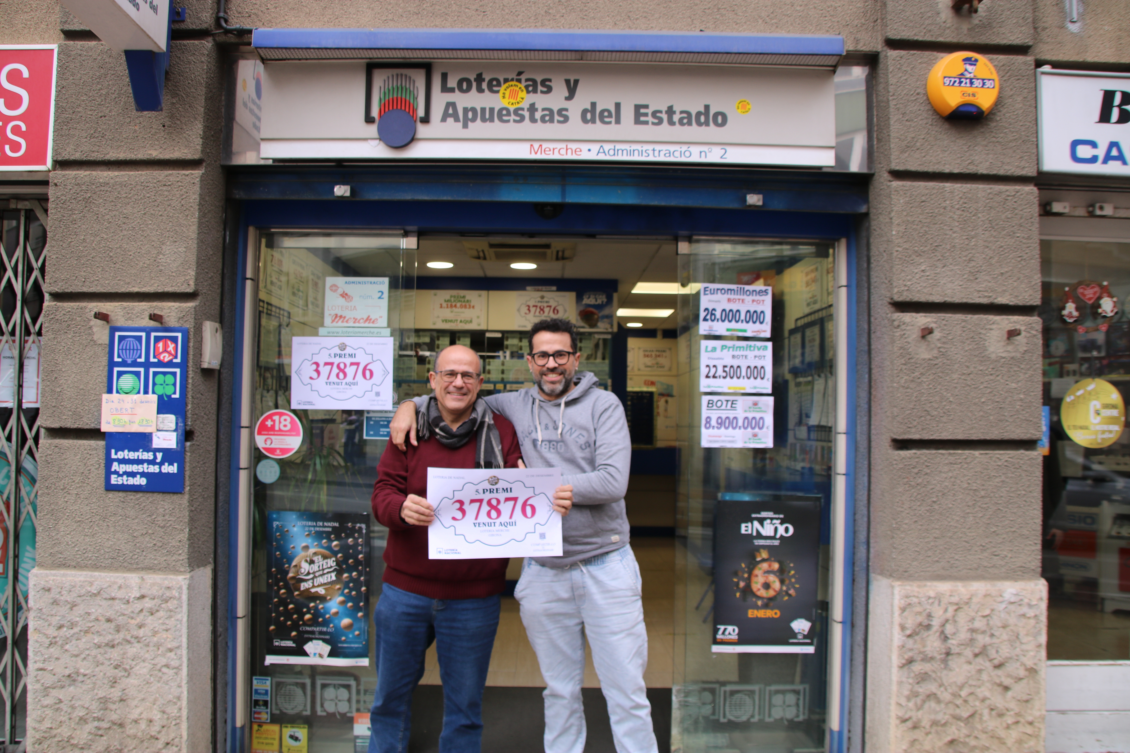 The two siblings managing the Loteria Merche in Girona celebrate having sold some tickets of one of the fifths prized numbers for the 2024 Christmas lottery