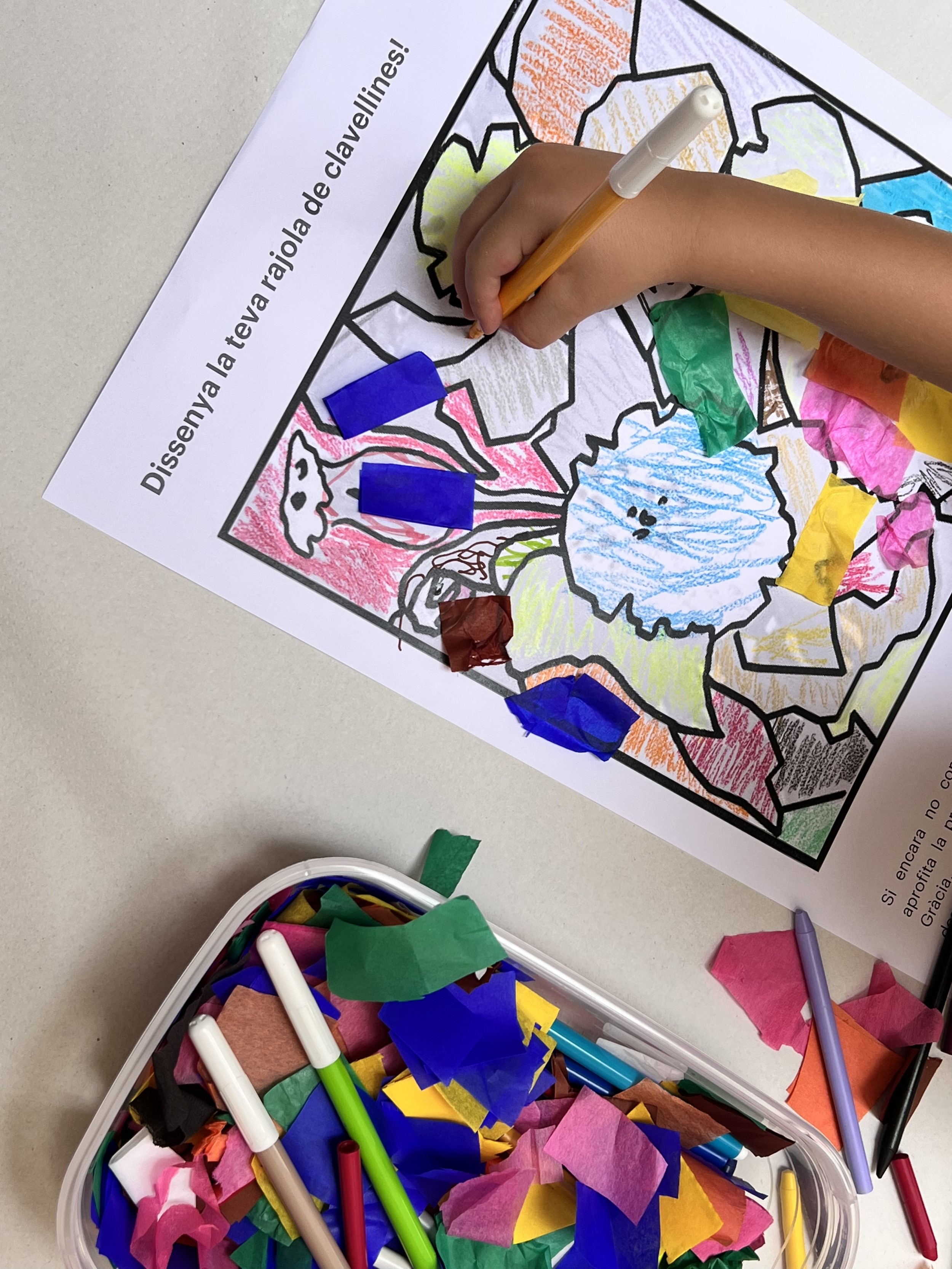 A child coloring in a Gaudí-inspired carnation tile