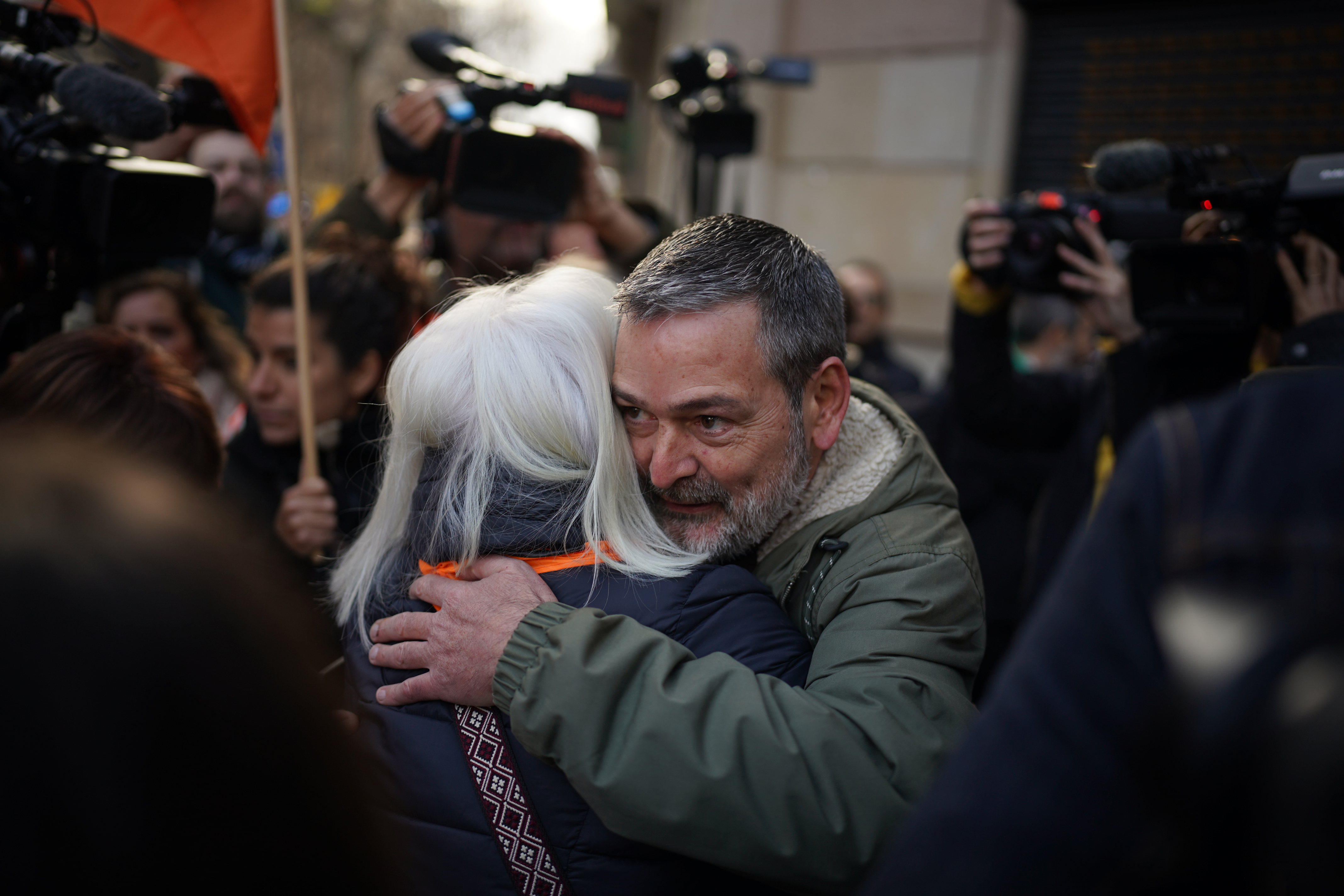 Affected Casa Orsola resident Josep hugs a colleague after the eviction was postponed