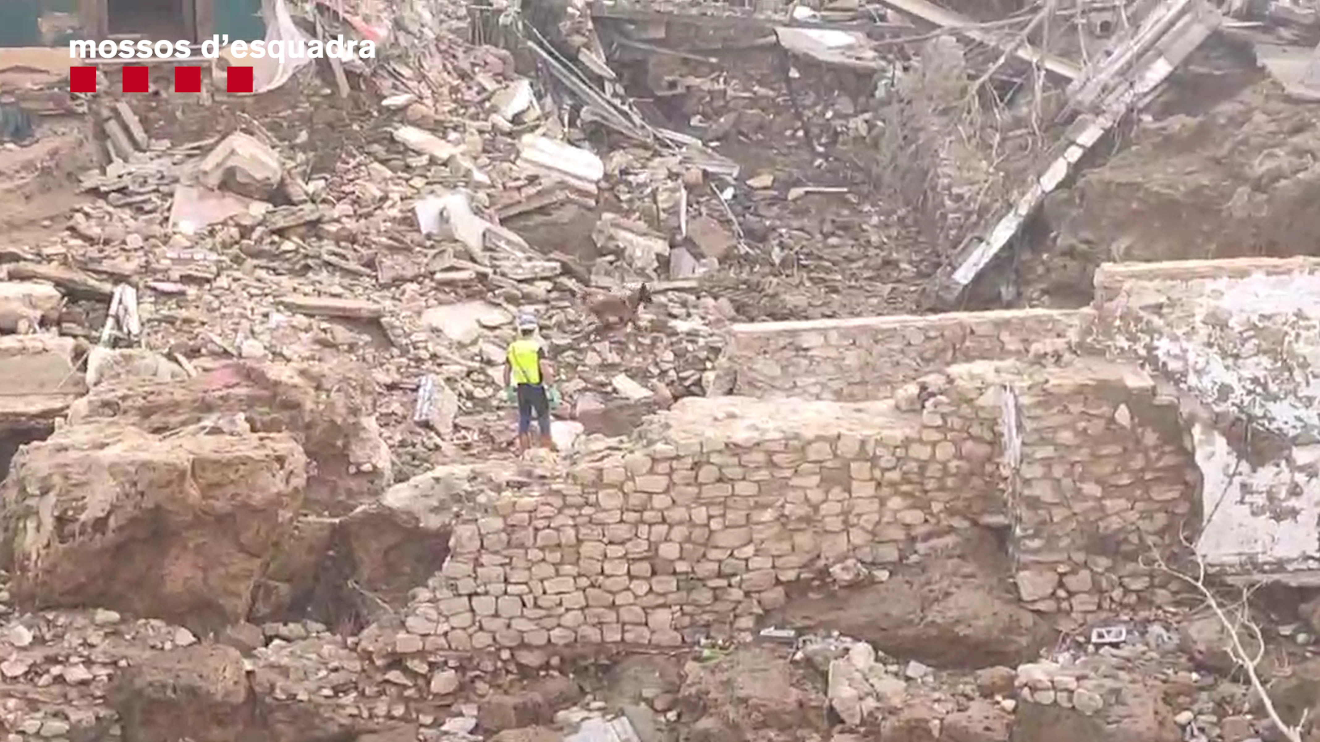 A police officer inspects damage from floods in Valencia