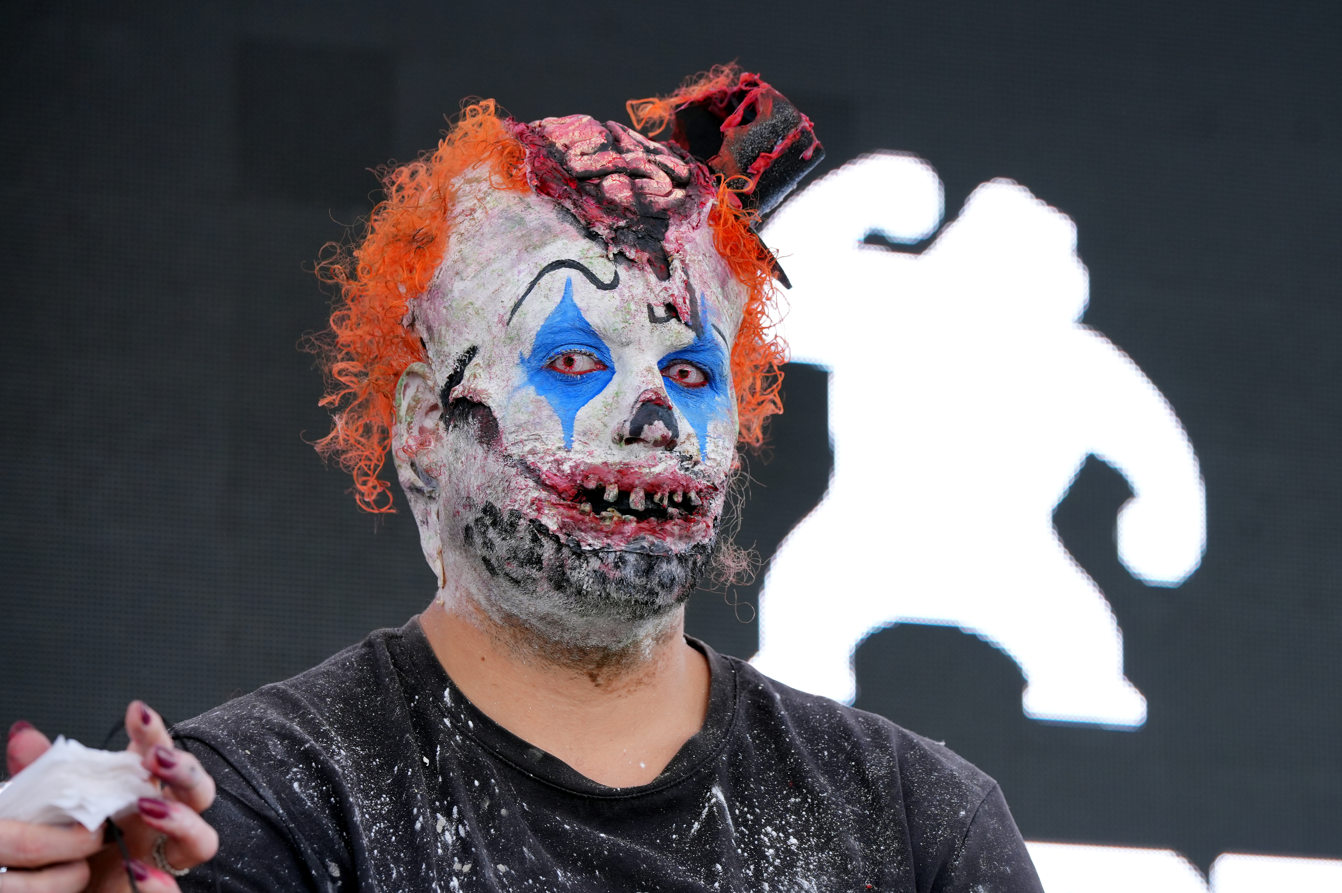 A person disguised as a scary clown ahead of the Sitges Zombie Walk