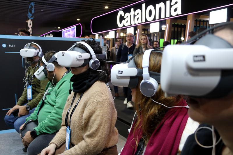 Visitors wear VR headsets at the Blit.studio stand at ISE 2025