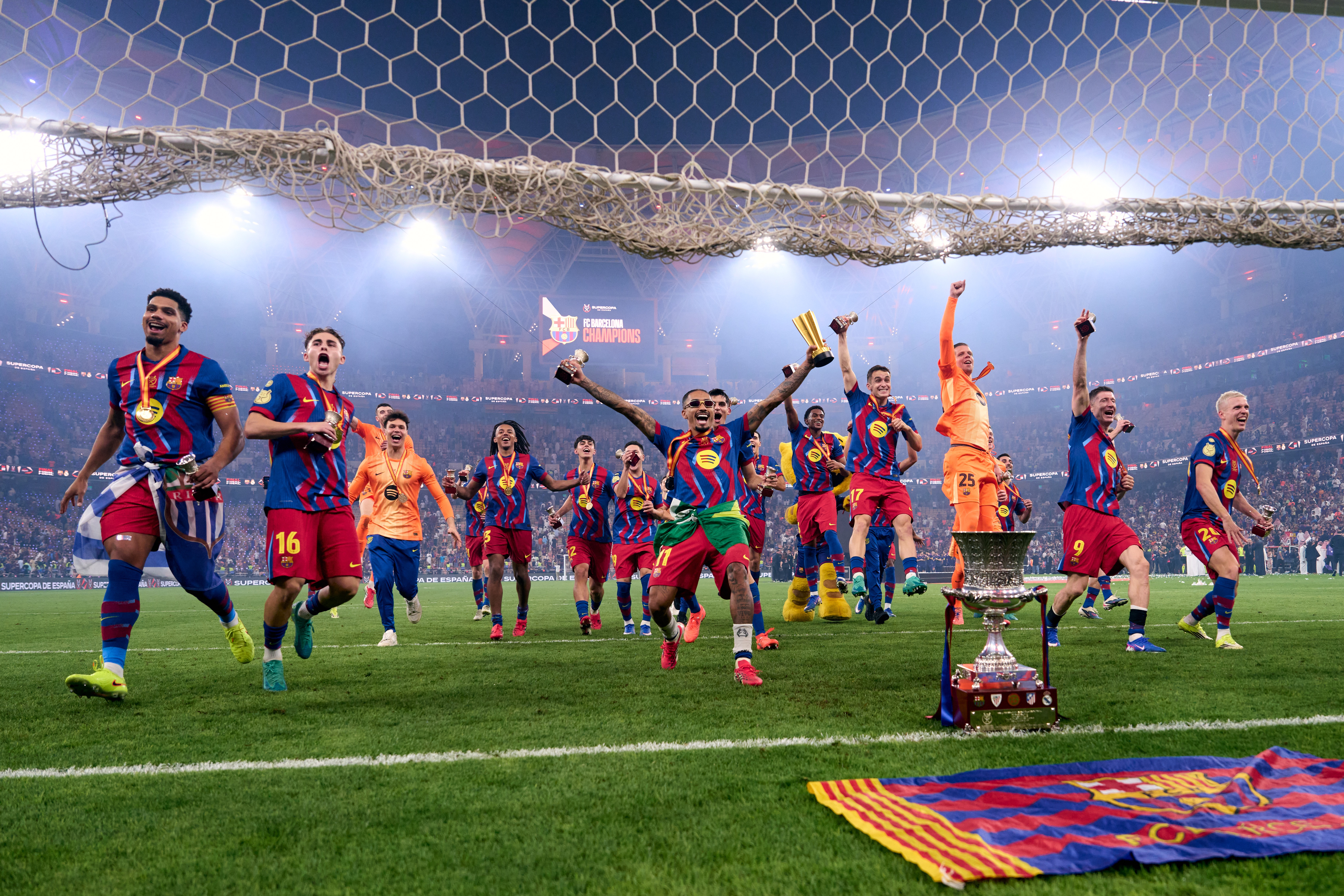 FC Barcelona players celebrate winning the Spanish Super Cup trophy against Real Madrid CF