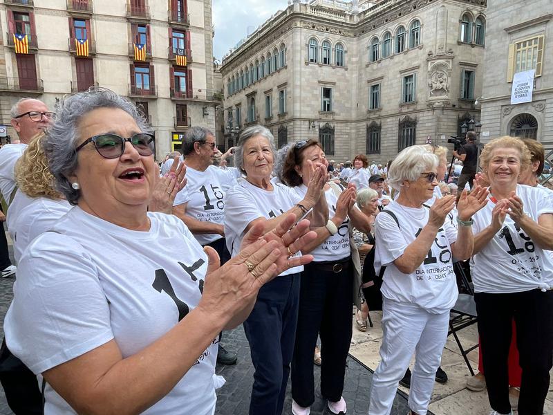 Attendees of the International Day of Older Persons gathering in Barcelona dance in Plaça Sant Jaume