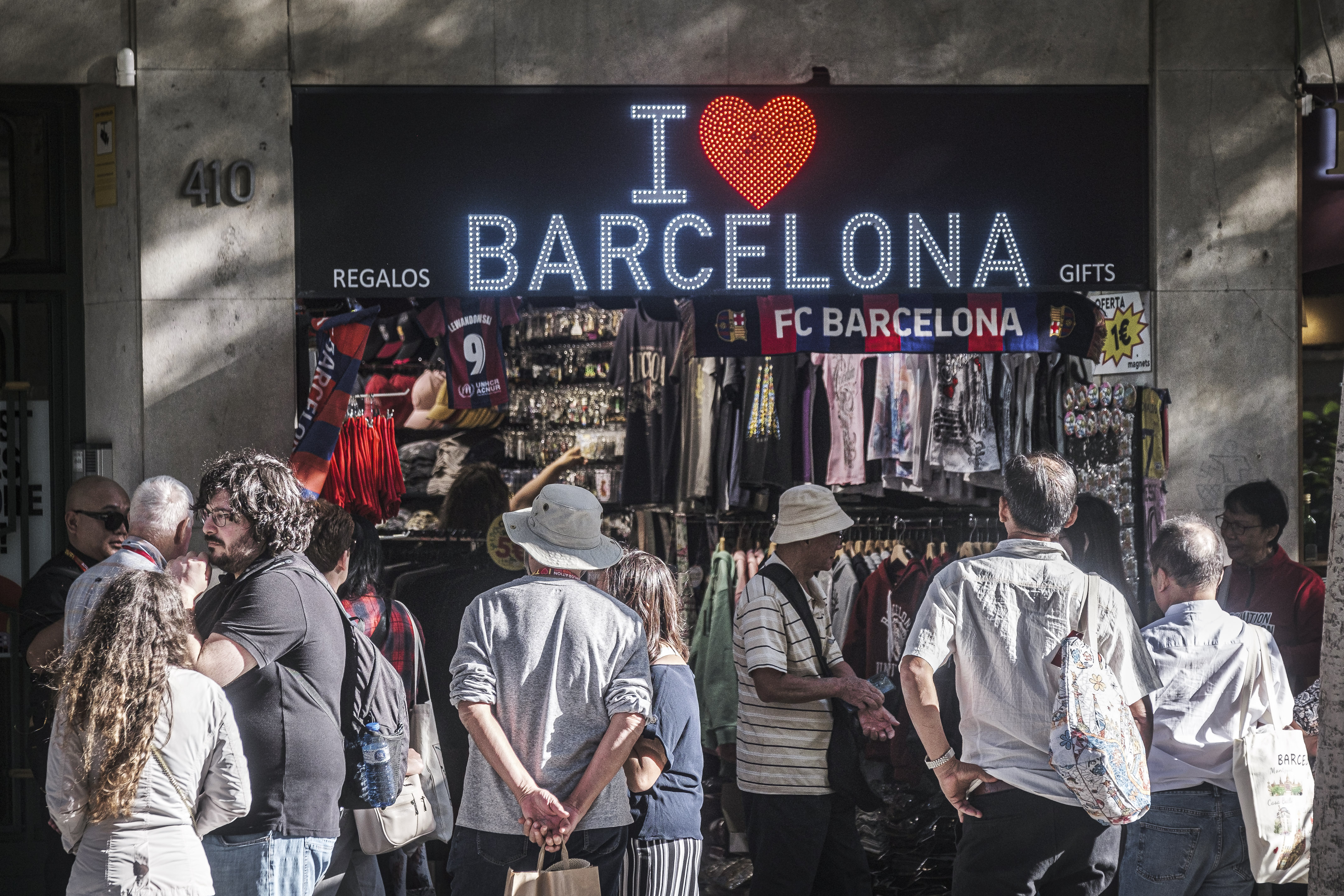 Tourists outside a souvenir shop in Barcelona