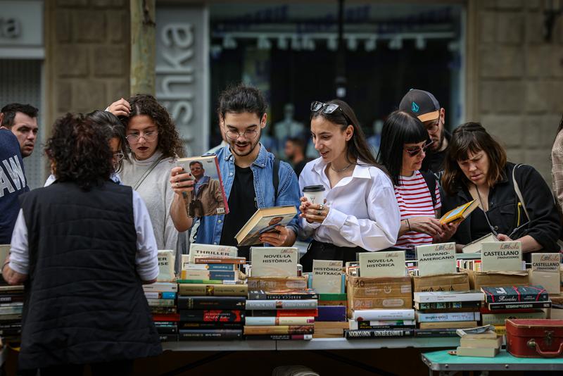 People looking at books at a stall in Barcelona city center on Sant Jordi 