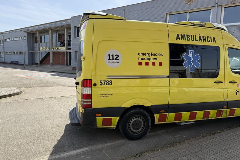 An ambulance in front of the Porqueres School, where the explosion occurred, injuring three students during an experiment