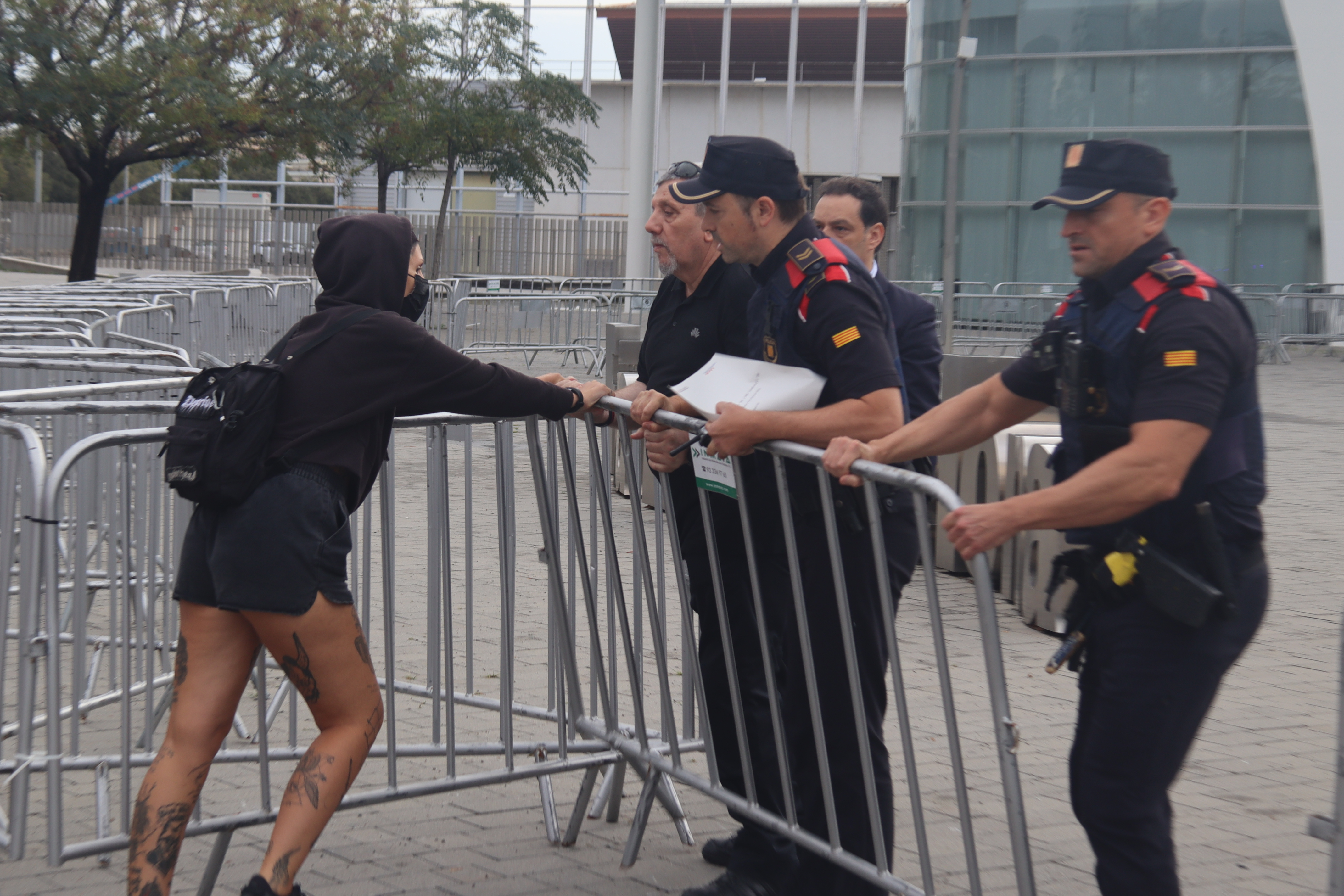 A demonstrator faces Mossos d'Esquadra police at The District real estate investors trade show in Barcelona in 2023