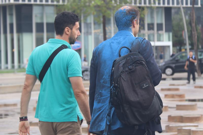 Attendees of The District with blue powder paint thrown by protestors