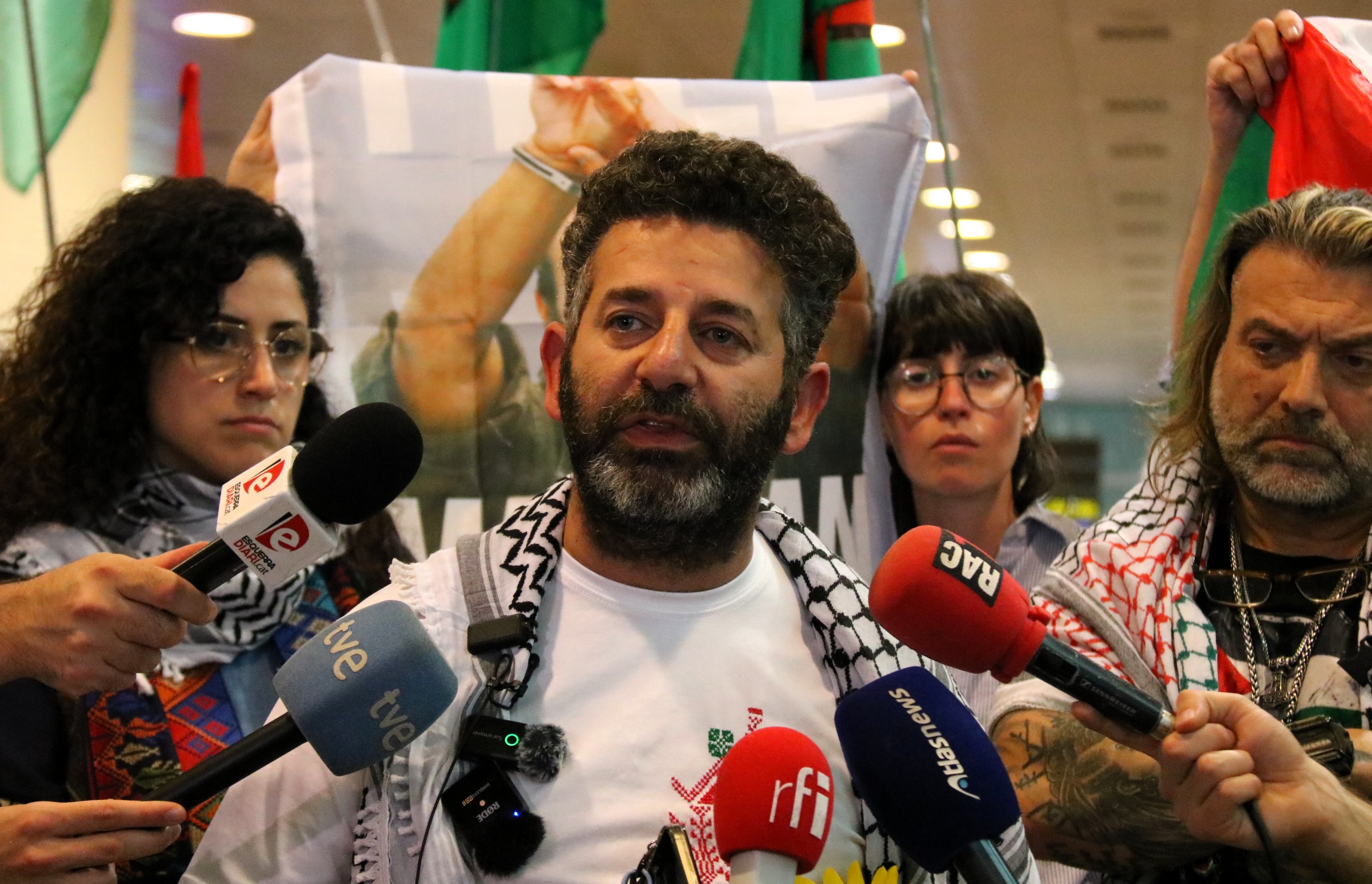 Activist Saif Abukeshek speaks to the media at Barcelona airport